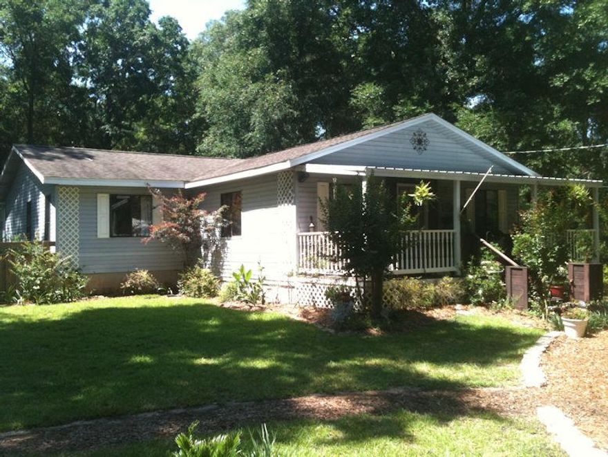 Owner in the process of moving so house is available now. Bring all offer. Beautiful low maintenance affordable home on a large acre wooded lot gives you lots of privacy. Large county front porch is perfect for sitting in those rocking chairs and enjoying a relaxing evening. Original home built in 1991 is off grade with master bedroom and Florida room added in 2009 on slab. Home was completed gutted and remodeled in 2009 with new bathrooms, new kitchen, new appliance, new HVAC, new roof, etc. Custom kitchen cabinetry with laminate counter tops. Heated and cooled Florida room off the kitchen gives that extra space for kids room, man cave, study or whatever your needs are. Small room has been added off the back for extra storage space. Refrig., washer, dryer do not convey.
