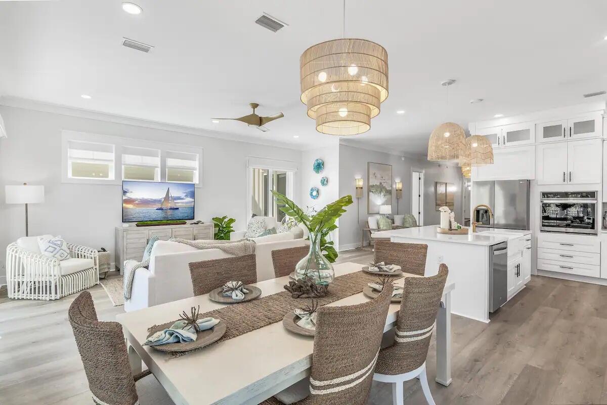 This new construction is a masterpiece of modern beach luxury. As you step through the front door, you are greeted by an airy, open living space that seamlessly blends contemporary elegance with coastal charm. The home features 4 bedrooms with king size beds and the 5th bedroom features custom built in bunk beds - making this the perfect vacation rental! The heart of the home is its expansive gourmet kitchen, fully equipped with high-end stainless-steel appliances, where families can cook up a storm and share meals in the large dining area. Splash in the heated pool or unwind in the jacuzzi. The outdoor grill awaits your family BBQs, and as the day turns to dusk, the fire pit becomes the perfect spot for roasting marshmallows under the evening stars.