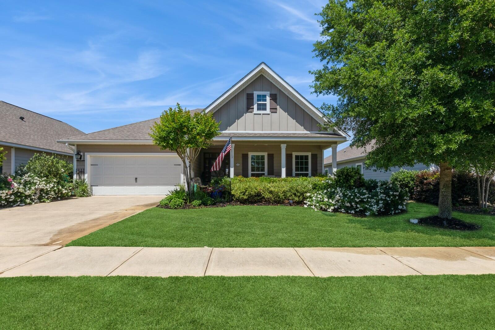 Take a look at this charming 3-bedroom, 2-bathroom home nestled on a unique lot backing up to Hammock Bay's Central Park! With its impressive curb appeal, thanks to the landscape architect-designed greenery, this home offers a beautiful and tranquil environment.Step inside from the spacious front porch and you'll be greeted by a bright, welcoming entryway. Upgraded tile flooring spans the main living areas and primary bedroom, providing visual appeal and easy maintenance. The living room and kitchen boast tray ceilings, crown molding, and custom blinds from American Blinds that enhance the home.