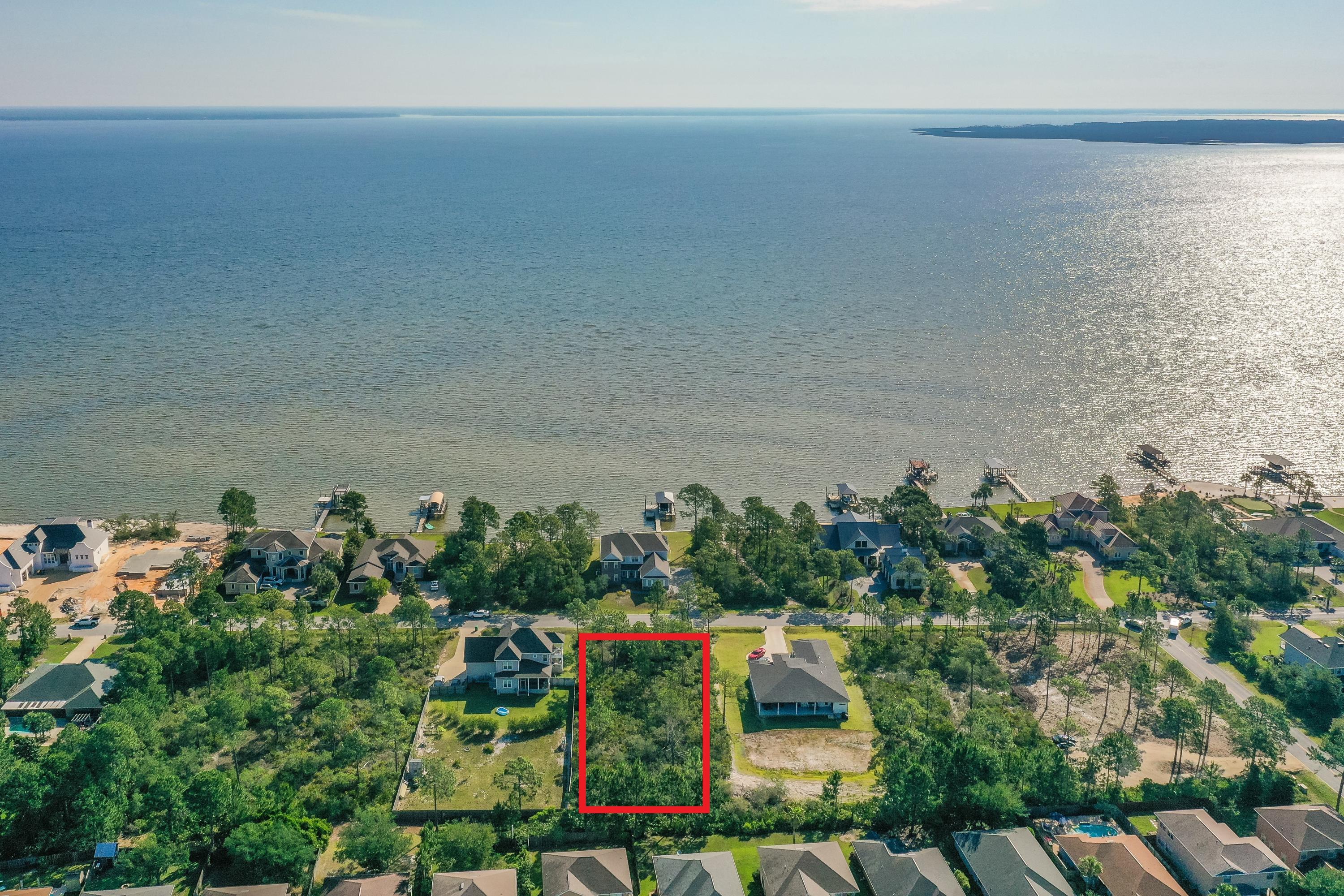 GUARANTEED VIEWS, NO HOA, NO BUILD TIMES!! Don't miss this amazing opportunity to own a over-sized lot in the desirable community of Driftwood Estates! Lot 10 is located directly across the street from Choctawhatchee Bay & is just over half an acre. Build your dream home & enjoy stunning bay views. Driftwood Estates is perfectly located with quick access to premier shopping, dining & entertainment. Spend the day shopping & dining at Grand Boulevard or Silver Sands Premium Outlets, or relax on the sugar white beaches along 30A. Everything you'll need to enjoy coastal living is right at your fingertips including nature trails great for biking, the bay or gulf for swimming, paddle boarding or kayaking, and parks for picnics.