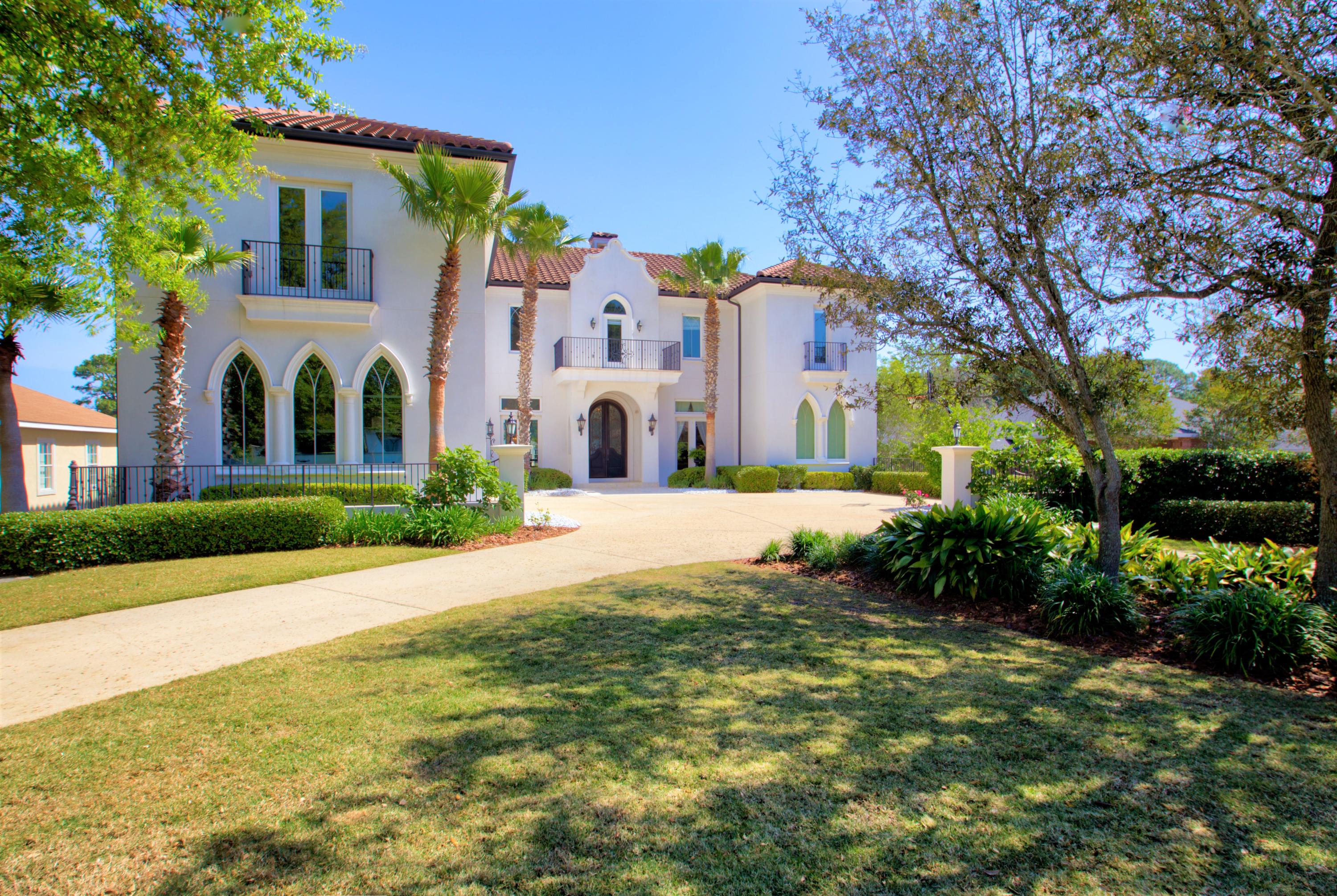 This elegant bright white smooth stucco Bermudan style home is situated thirteen feet above sea level on a tranquil deep-water lot in Indian Bayou. The boat dock, spanning the width of the fenced backyard, is constructed with weather proof decking which includes both a covered boat and Jet Ski lift. The home has a warrantied hard coat stucco exterior and commercial grade tile roof. Also featured is a fully renovated heated pool and spa with stacked stone and glass tile along with a water fall that is elegantly showcased at night by state-of-the-art fiber optic lighting controlled by an Aqua link key pad system. The expansive outdoor kitchen and living area are ideal for al fresco dining and entertaining. The automated retractable screens allow for yearlong outdoor enjoyment.