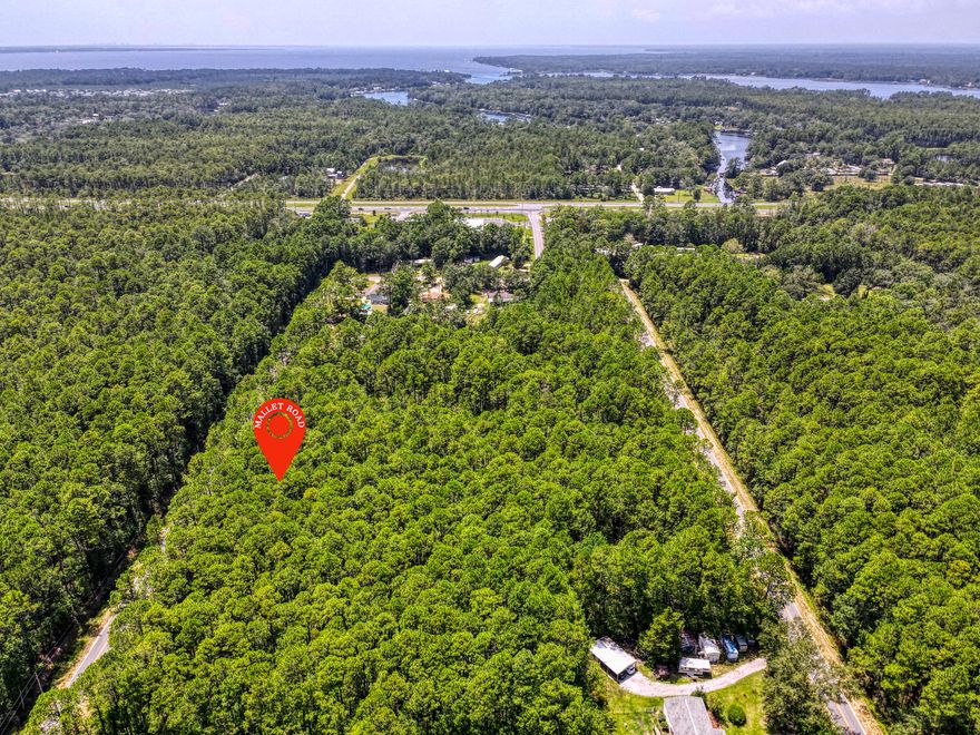 This wooded lot is approximately 1.89 acres and conveniently located in the beautiful growing City of Freeport! A few miles away from US-331, US-Hwy 98, FL-20 and 18 miles from I10.. Great opportunity to build your dream home (vacation home) or place a mobile home. This area is zoned Rural Village, private well and septic must be utilized (no utilities are in place at the moment). Enjoy the many benefits of living around nature but with easy and close access to nearby cities and towns (Close by popular cities: Destin Florida, 30A / Seaside and Panama City Beach)Daily errands and major services are located within 5-8 miles. Close distance to shopping centers, hospital, gulf courses, great food and our sugary sand beaches of the Emerald Coast.