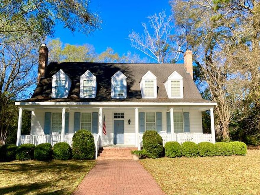 A RARE OPPORTUNITY! Beautiful residence on Circle Drive faces the lake in the DeFuniak Springs Historic District. Built in 1988, this gorgeous property features 3BR, 3BA, and a totally unique floor plan with original hardwood floors throughout, and a primary bedroom & bath on the main floor. You'll be amazed at the gracious scale and character of the spacious rooms, with crown molding, built-in bookcases, china cabinets,  and wood-burning fireplaces. Kitchen has stainless sinks, an island with breakfast bar, white cabinets, and a computer desk. All three baths feature meticulously maintained original tile. A million-dollar view of Lake DeFuniak from the huge front porch and a private backyard with mature shrubbery & a circular drive of red-brick pavers completes this one-of-a-kind listing.
