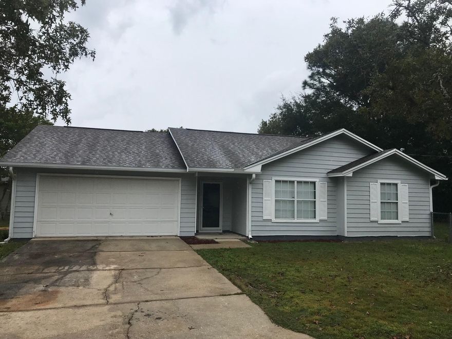 Beautiful 3 bedroom 2 bath home for sale in Crestview! Tall ceilings, fireplace, and open floor plan. New roof, fresh paint, new appliances, and new flooring throughout! Pendant lights above the fireplace. Laundry room off of kitchen. 2 car garage. Large fenced in back yard. Vacant and easy to show!