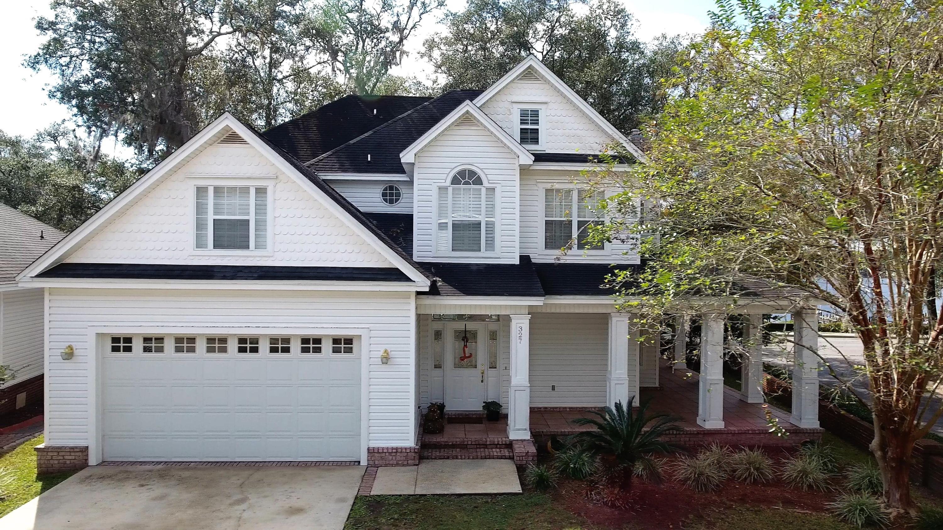 Grand Oaks is known as one of the most charming water front communities in the area. Waterfront features without many of the negatives common with direct waterfront living. Grand Oaks is located across the street from Niceville's Boggy Bayou, nestled between majestic live oaks, each home site is afforded a waterfront parcel with direct access to the bayou, Choctawhatchee Bay and eventually the Gulf of Mexico, via Destin's East Pass. This custom built home sits in a premium location within Grand Oaks, fronting along Bayshore Drive, it boasts unobstructed views of Boggy Bayou. Its water front parcel is directly across the street and through the common wall gate. This home truly has ''great bones'', taking advantage of its corner location with a wrap around porch and columns.