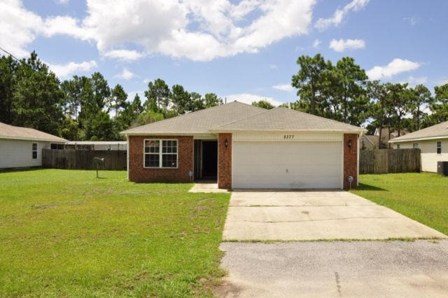 REO. If your must-have list for a home includes a spacious backyard, convenient location, and fantastic floor plan, then this home could be the one for you! Upon entering the home, you will notice the vaulted ceiling in the living room which makes the room feel even more spacious. In the kitchen you will find a breakfast bar and a convenient dining area right off of the kitchen. The master bedroom offers lots of space and the ensuite comes complete with a double vanity and a garden tub to soak in after a long day. Entertain guests in the screened porch and enjoy the spacious, fully privacy fenced backyard. Conveniently located just minutes from schools and the beautiful Navarre beaches!