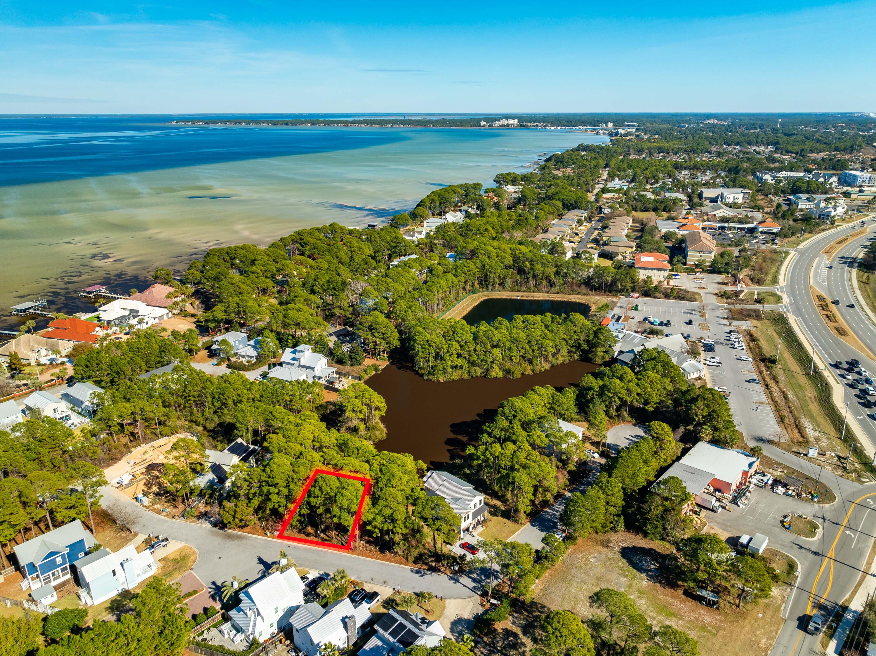 Escape to paradise and build your dream home on this sought-after waterfront lot in the serene Bayshore Pines community. Nestled in a low-density, lakefront neighborhood, this property offers the perfect blend of tranquility and convenience. Just a short golf cart ride to the beach and a quick walk to the bay and boat ramp, this location is ideal for enjoying the best of coastal living.With ample space to create your forever home or an ideal short-term rental investment, this lot provides endless possibilities. Plus, with no HOA fees, you have the freedom to make this property truly your own.Enjoy the convenience of nearby Miramar Beach amenities, with easy access to the boat launch at Legions Park via a scenic side road. The lot itself overlooks a peaceful spring-fed pond... that flows into the bay, offering a unique opportunity to fish right from your backyard. Hop on your golf cart and head across 98 to soak up the sun at the beach. Don't miss this chance to own a piece of paradise!