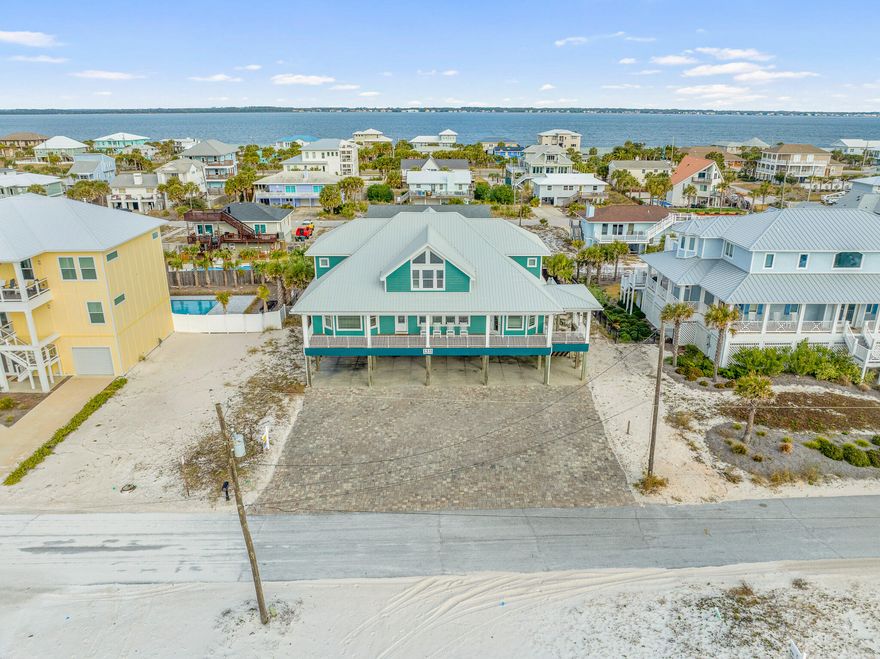 Welcome to this breathtaking 7-bedroom, 8.5-bathroom coastal oasis, offering 4,624 sq. ft. of elegant living space and Gulf-front views. Situated on a large gulf view lot, this home is the perfect blend of elegance and comfort, with thoughtful upgrades throughout and multiple areas to unwind and entertain. Enjoy the gulf breeze from one of the home's large decks, both front and back, designed for outdoor living and stunning water views. With over $277,000 on the books for 2025 rental income. Welcome to this breathtaking 7-bedroom, 8.5-bathroom coastal oasis, offering 4,624 sq. ft. of elegant living space and Gulf-front views. Situated on a large gulf view lot, this home is the perfect blend of elegance and comfort, with thoughtful upgrades throughout and multiple areas to unwind and entertain. Enjoy the gulf breeze from one of the home's large decks, both front and back, designed for outdoor living and stunning water views. Off the balcony is a spacious, open-concept design which features a generous living space flowing into a large expansive kitchen, ideal for both daily living and hosting guests. The kitchen boasts sleek quartz countertops, updated cabinets, and plenty of seating space. On the main level there are four large bedrooms, including the Gulf Front master. All feature en-suite bathrooms and large walk-in closets. There is a half bath located right off the back deck for ease of access from the pool area and a large laundry room with additional storage and fridge. Upstairs includes another large second living space and the remaining three bedrooms and four full baths featuring updated bathrooms and newly renovated spaces. Also included upstairs are three separate cozy cubby bedrooms that are ideal for guests or versatile use. With many additional features and upgrades including a new pool liner, new natural gas pool heater, new exterior HVAC units, new hot water heaters, metal roof, fully furnished, ext. The exterior of the property features an oversized carport and large paver driveway which can host up to 15 cars and host large events for additional use or income opportunities. Maximizing the use of space, this property is a top-tier vacation rental, consistently grossing over $225,000 annually, offering a lucrative investment opportunity. Rental revenue for 2025 is expected to be over $300,000 with currently $277,000 on the books. This rare gem is truly a one-of-a-kind opportunity  for both private living or as a profitable rental.