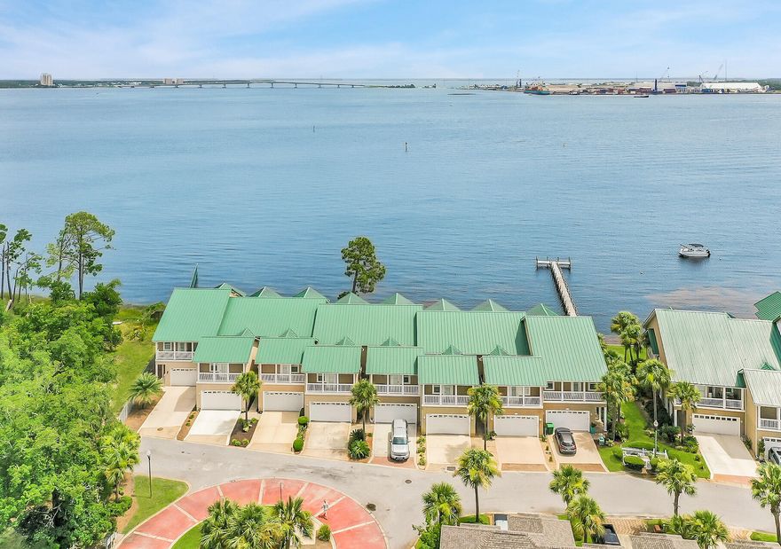 Privacy, serenity and pleasure all come together to create the perfect oasis of waterfront living on the Bay. A rare find with a 2-car garage, solid concrete construction, pure views of the Bay, but without the maintenance. Wake up each morning in your waterfront master suite to gorgeous sunrises from your private balcony and spend each night relaxing on the docks watching the sunset. Moor your boat for a few days behind your townhome and enjoy the waterfront lifestyle you desire! Very spacious with an open floor plan and  high ceilings. Light, bright and airy throughout, this home is turn-key with amenities you'll never want to leave. In the highly regarded community of Pelican Bay, off Magnolia Beach Road, this bay front townhome offers endless views, peaceful surroundings & Gulf access. This recently renovated townhome offers a 2-car garage, covered patios on the main living room and master suite as well as three spacious bedrooms and 2.5 bathrooms, 9' ceilings, LVP flooring, crown molding, black stainless appliances and plenty of storage throughout. Residents can enjoy the clubhouse within a full kitchen, bay front pool & spa, two community docks and a nature walk. This townhome is waterfront living at its finest!