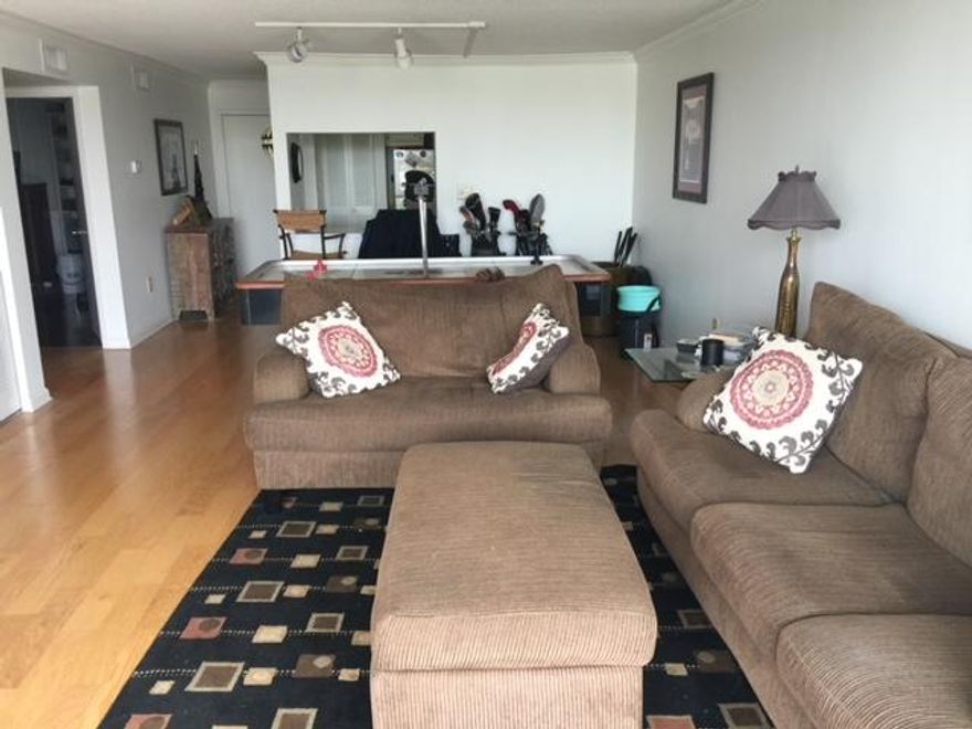 BACK ON MARKET. Buyers financing fell through. $10,000 price reduction. Ready to sell. This Harbor front condominium is located on prestigious Holiday Isle and has a direct view of the Harbor. Upgrades include beautiful wood flooring in living, kitchen and bedroom and large custom tile in the bathrooms. Condo is being sold unfurnished. Dolphin Point amenities include a Harbor front heated pool, tennis court, owner clubhouse, private boat docs, sandy beach, shuffleboard, gas grills, security & onsite manager. Boat slips may be purchased or leased when available. Enjoy water activities, amazing sunsets and a 5 min walk to the beach. SF is approximate and should be verified by buyer.