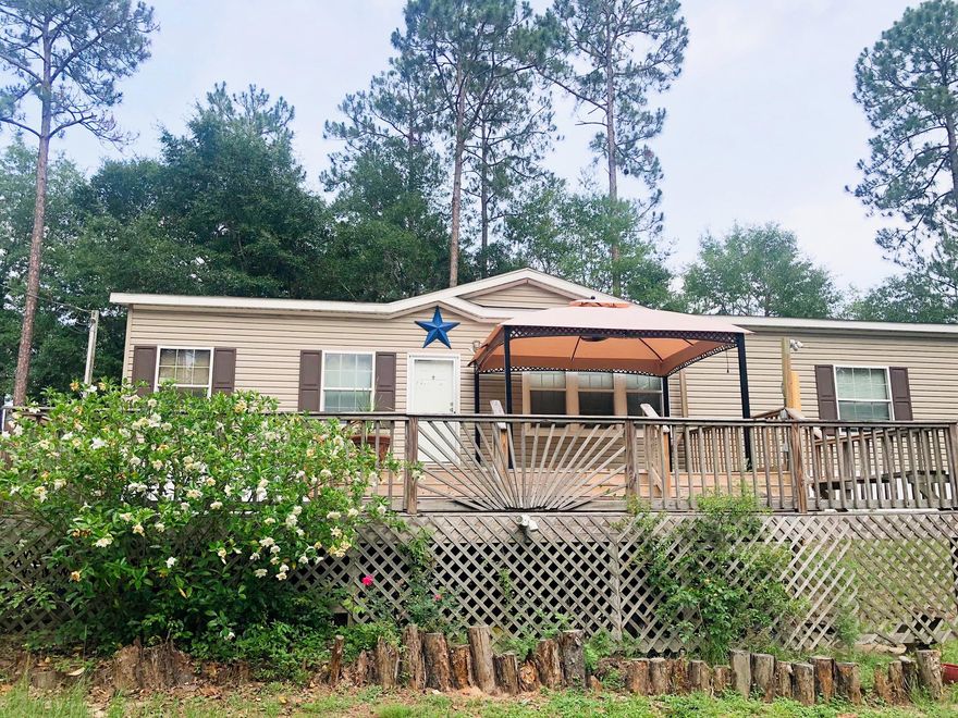 This beautiful and spacious maufactured home is sitting on 2 acres, just outside the city limits.The home is 3 bedroom, 2 bath, approx. 1500 sq ft., with an open floor plan with a beautiful kitchen that includes all appliances, an island/bar. The living room has a built in TV stand. All rooms have walk in closets. The master bedroom has a garden tub and separate shower with double vanity. The home has a newer a/c unit with the NEST smart thermostat.