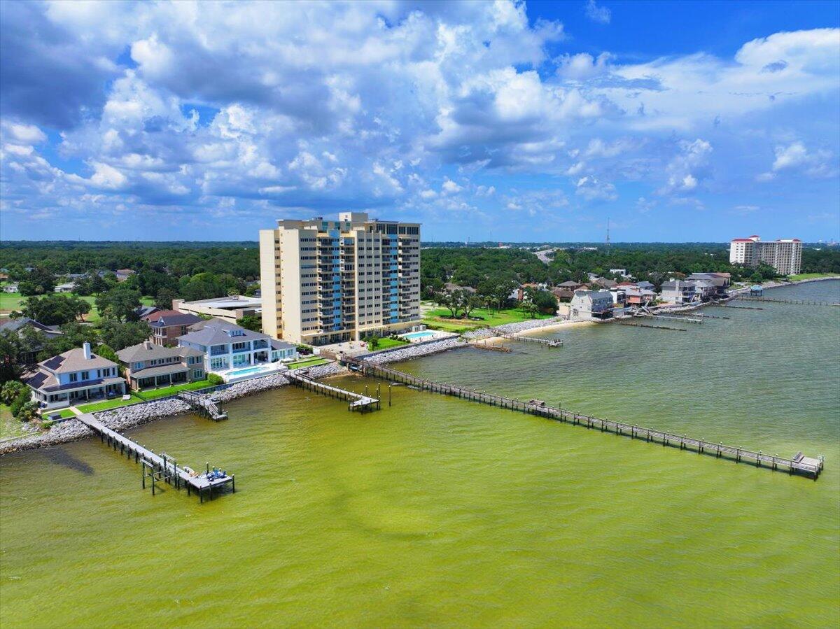 Furnished 2Br/2BA WATERFRONT unit at Bayshore Condominiums! Corner Bayside unit, gorgeous views, fantastic windows! Only corner units have totally open balconies, new insulated balcony door 2021, totally remodeled 2021, 01 units are on best side -- views of Pensacola Naval Air Station and 3 mile bridge, complex has largest pier on Pensacola Bay, watch Blue Angels practice right from your balcony. Pensacola Country Club just up the road. Kitchen updates include refaced cabinets, new countertops, appliances, flooring, lighting -- Bathroom has new walk in shower with new vanities, toilets, flooring. Washer dryer connection for Euro sized machines. NO SHORT TERM RENTALS! No pets other than ESA and service animal