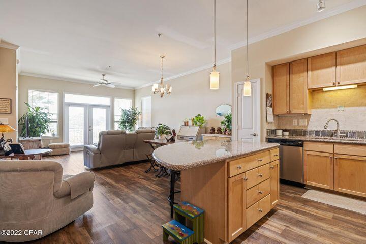 One of our new favorite condominium units! This beautiful condo has so many wonderful features such as an open floor plan, high ceilings, custom crown molding, LVP flooring throughout the unit, granite countertops, balcony, tons of storage and a bonus room (perfect for a bunk room or office). Not only is the unit amazing the Resort of Island Reserve is remarkable! This Gated community has wonderful amenities including a gorgeous one acre, resort style lagoon pool with rock waterfall, state of the art fitness facility, billiard & game room, Media Center with 100'' Theater Screen, Parking garage with Direct Access to each floor. There is also a basketball & pickleball court. This is a brilliant location close to shopping restaurants, beach & town. BTW! NO SHORT TERM RENTALS ALLOWED.