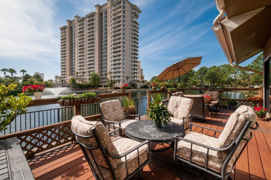 This beautiful end unit townhouse has amazing lake views. It is one of the most spacious floor plans with two bedrooms downstairs, master suite upstairs with additional bedroom off the master bath. The second level also has a bonus open loft area, which is perfect for additional sleeping area, game room or second living room.The lake views are breathtaking from the large outdoor balcony and the master bedroom balcony. Also, a convenient pool for Beachwalk Villas is within walking distance. Unit sold unfurnished, some items are negotiable. Patio furniture to stay with property.