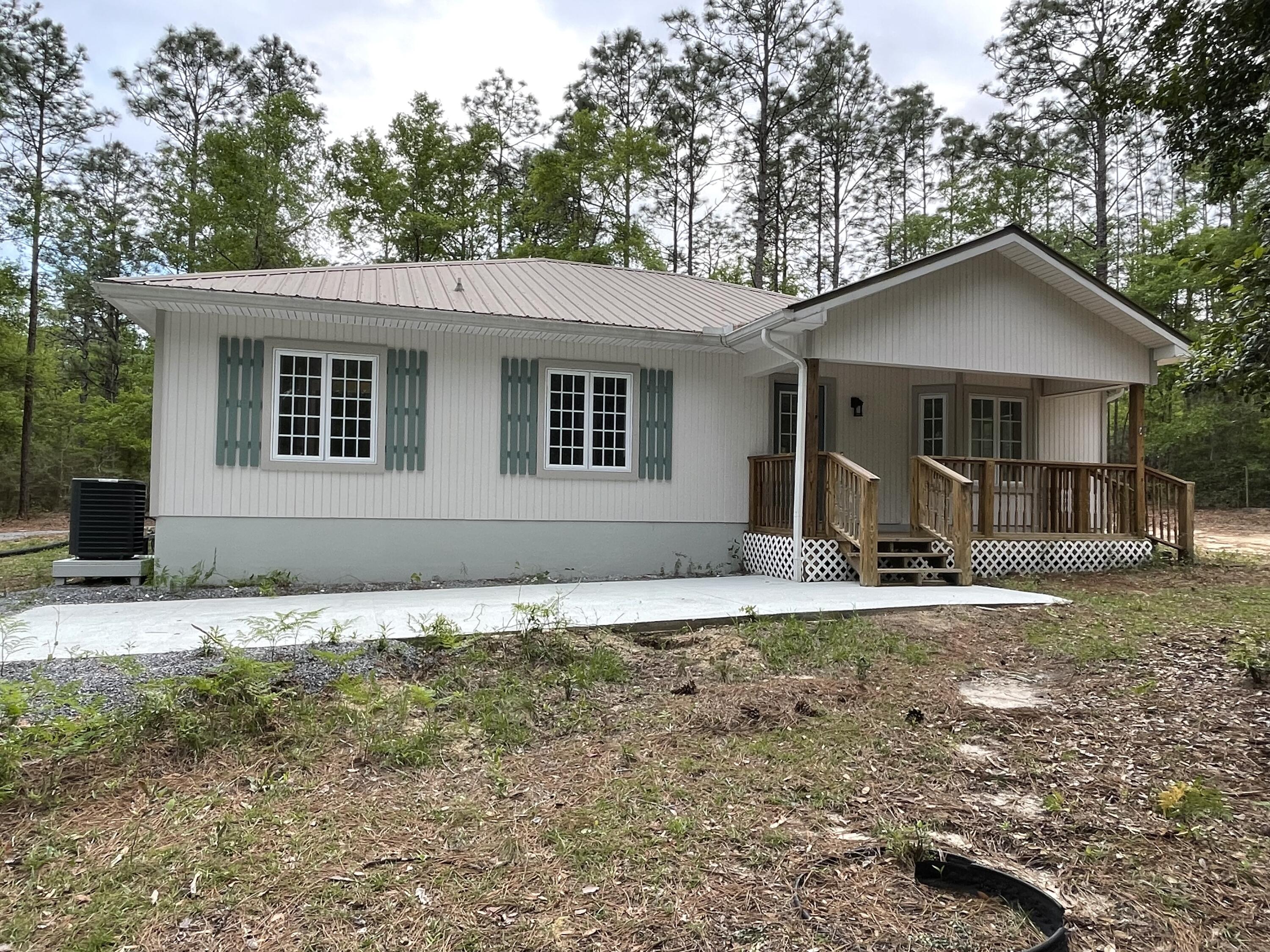 GETAWAY HOME? RETIREMENT DOWNSIZE? SHORT-TERM RENTAL? OR ALL THREE?! Darling 2 Bedroom / 2 Bath Cottage-Style home in a fabulous central location on a cul-de-sac, nestled on its own 4.75 beautifully wooded acres. just waiting for you to CREATE YOUR OWN VISION!Whoever uses this versatile property, be sure to bring your RV/Fishing boat, or your bird-watching book, or your hunting gear, or your walking boots, etc., etc, etc. Plenty of land between you and your friendly neighbors makes it very private.  You are just minutes from all the parks, springs, beaches where you can play to your heart's content:  hike, swim in the bluegreen waters of the Gulf, hunt the plentiful deer, or canoe the many natural Springs. Property is Flood Zone X. No restrictions or HOA to deal with. A great local location south of I-10 with easy access to I-10, US 331 making it very convenient for places one might want to work, play, or relax.  
Whether it's the very cute front porch or the spacious back deck, both lift you up with your own private nature.  Lots of space to hang out!  Maybe add a swing for yourself, and put a few rocking chairs, to indulge yourself in the beauty of nature.  Walk right out into it: both from the open-concept, kitchen/living and dining room area, and from the primary bedroom itself. Fill your night with the evening air from the many screened sidelights and windows. 

Occupants can enjoy the outdoors, indoors as well! The home's many gorgeous (and sturdy) casement windows and the multiple skylights offer plenty of natural light: all day, early morning, and late afternoon.  Recently painted inside and out with new flooring, the primary bathroom has two new pedestal sinks. Also, a cute new well pump house was built and driveway parking space next to the home.

Enjoy much-enhanced comfort and security due to the home's leading-edge ICF construction, which has an R-value between R-20 and R-28 throughout the life of the homein contrast to a stud-built home with an R-value of only EIGHT! ICF homes use 60% less energy loss than a wood-frame wall. 

But ICF homes are not only energy-saving. ICF walls are far safer in tornadoes and hurricanes. You will definitely enjoy that solid, safe feelingand quiet as well, because ICF also provides a great sound barrier, giving you that feeling of country privacy.  ICF constructed homes are known to be mold and mildew resistant, very beneficial in the Florida humidity. (Learn more at https://www.quadlock.com/insulated-concrete-forms/ICF_energy_performance.htm)

Located just 30 minutes north Gulf of Mexico, the property is only eight minutes from the big-box hardware, and four minutes from the new Chic-Fil-A. Yet, with all this convenience, you are completely isolated by the heavily wooded area. You're no more than 15 minutes from schools, shopping, and the historic business district. You will also be just a few minutes to Interstate I-10 and U.S 331 for easy access for commutes to Crestview, Destin, Niceville, Freeport, Panama City Beach, Eglin AFB, Hurlburt AFB and 7th Special Forces.

This area offers so much more than one can articulate in this listing. Here are few mentions:

-DeFuniak Springs FL is host to Lake DeFuniak, one of only two perfect-circle spring-fed lakes in the world, with a beautiful walking trail, and a dock usually open to public swimming and fishing. The annual Christmas Lights Festival, enjoyed by folks from the entire region, has 10 million lights around the lake. Lake DeFuniak's many classic antebellum homes include the spectacular historic Chautauqua building. 
-The historic downtown business district includes many dining opportunities from fast food to cafe to Southern to New Orleans to international. Satisfy any taste you have while enjoying the unusually wide range of shops and stores. DeFuniak even has its own Chautauqua Winery (to delight you) and Emerald Coast Zoo (to delight the grands)!

-Only six miles away, indulge yourself on the 580-acre, well-stocked Kings Lake reservoir north of town. Your chances of getting a bite here are good whether you're fly fishing, bait-casting, or spinning. Kings Lake is full of bream/bluegill, crappie, black bass, catfish, and largemouth basssuch as a state-record 17-1/4 lb bass.

-The Gulf of Mexico and Emerald Coast is home to Florida's Famous, Sugar-Sand Beaches. Visit any beach you want using this property as your hub. Enjoy the World Famous Crab Island in the Destin FL channel. Public beach access within 35 to 1 hr include parks such as Grayton Beach, Henderson Beach, Miramar Beach, Santa Rosa Beach, Navarre Beach, Panama City Beach. The pristine National Seashore Monument is only 1 hour away. Whereverenjoy the perfect day at an undeveloped beach and then retreat to your private, uncrowded acreage and home.

-This property is short drive to many State Parks and private venues providing hunting, hiking trails, crystal-clear fresh-water swimming holes, springs, and water sports. A short list includes:
-Vortex Springs, Ponce De Leon Springs State Park, the spring-fed playground at Morrison Springs State Park, Blue Springs, and many others
-Numerous local sections of the Florida Trail which runs the length of the state (Eglin, Nokuse, Lafayette Creek)
-Lakewood Park, Florida's highest point
-Blackwater River State Park (54 minutes)
-Falling Waters State Park (41 minutes)
-Florida Caverns State Park in Marianna (65 minutes)

Information contained within this listing is deemed to be accurate but is not guaranteed. Buyer is responsible to complete all due diligence and verify all information provided.

