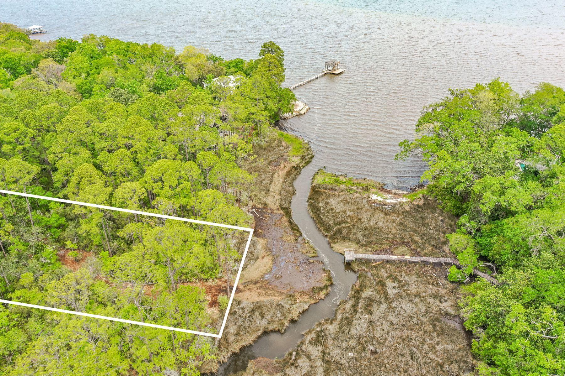 This lot will have some views of the bay and it situated in a quiet neighborhood with a few restrictions on building. It backs up to a small canal that leads into the bay, where you can put in your canoe or kayak