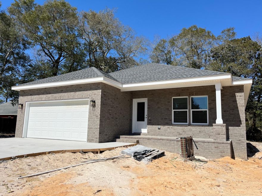 NEW CONSTRUCTION by Hi Lite Homes in Villa Tasso, one of the fastest growing communities in the Niceville area!! This adorable and AFFORDABLE 3 bedroom, 2 bath brick home with a 2-car garage I located on a large .56 acre private lot at the end of a quiet street. The open floorplan features a large living area and dining area that are both open to the wonderful kitchen featuring gorgeous granite counters, white cabinetry and stainless appliances including a refrigerator! The master bedroom suite offers a walk in closet with built ins and a bathroom with a dual sink vanity, a soaking tub and a separate shower. The two additional bedrooms are good sized and share the second bath. There is a large covered front porch AND another large back porch overlooking the spacious back yard. Additional