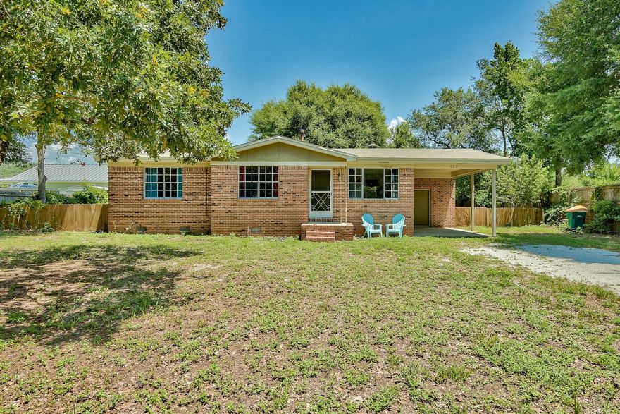 Charming 3-bedroom ''fixer upper'' brick house built in the 60's with an attached single car carport located on a large lot in the heart of Destin. No HOA! Perfectly located near premier shopping, dining and beautiful white sand beaches. The house is only one block from the Destin Elementary School and just minutes from Destin Harbor. The renovated kitchen has a new tile floor, granite counters, added backsplash, new cabinets and new Whirlpool appliances. The bathroom features a granite shower & counter as well as a new tile floor. The home boasts real hardwood floors throughout. Enjoy the fenced back yard & front yard has beautiful trees and plenty of space for additional parking. You could even park a boat & trailer and have Joe's Bayou boat launch nearby. Bring us an offer.
