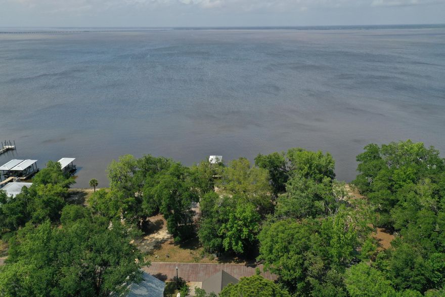 This incredible 50' bayfront lot sits directly on Choctawhatchee Bay in quiet and charming neighborhood of Grayton Bayou. The neighborhood offers a community pool and the convenience of an existing seawall. Reasonable architectural guidelines keep home designs consistant for an ideal permanent or secondary residence in one of Santa Rosa Beach's most desirable bayfront enclaves. A ten-minute stroll or a short bike ride will get you to the brand new Bayside Ranchettes public park which was recently added to this up and coming neighborhood to offer the community a place to picnic and launch kayaks and canoes. This location is perfect for fishermen and boating enthusiasts who want to build their dream home with their own private dock.