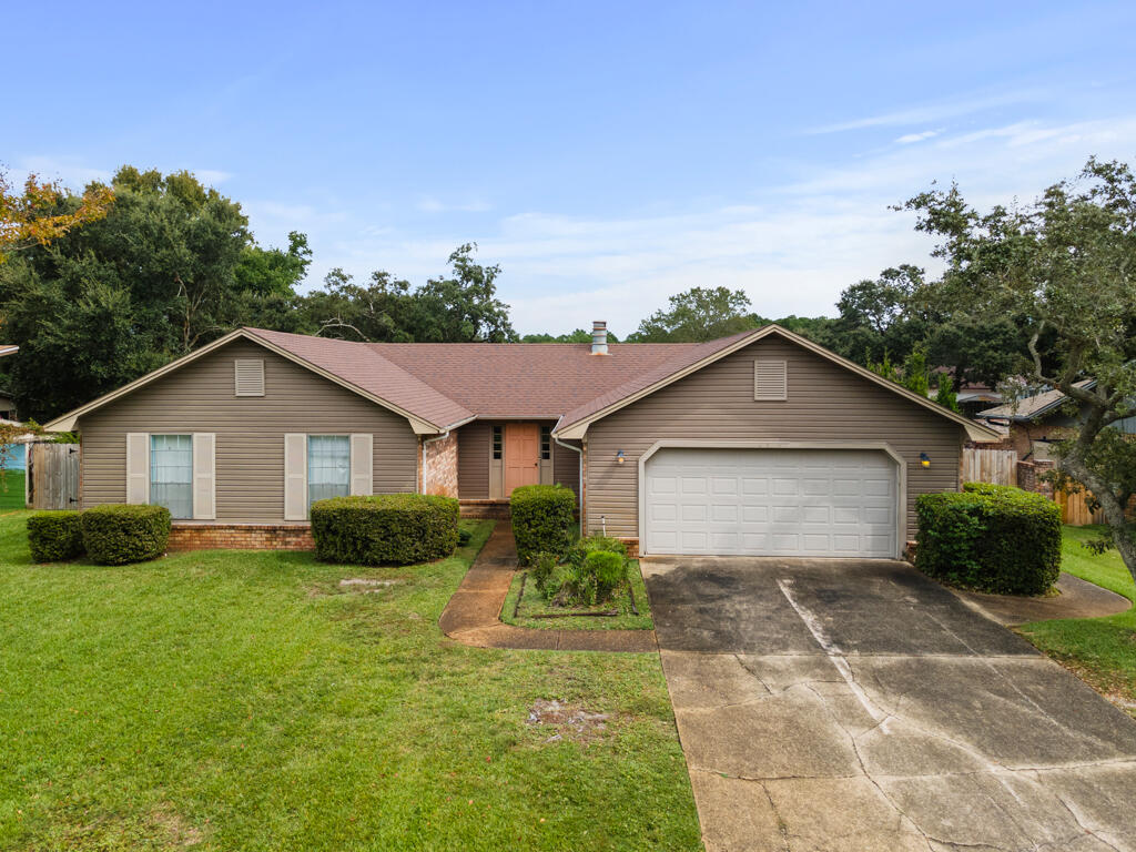 Unlock the possibilities of this 4-bedroom, 2-bathroom home located in the Villa Venyce community of Gulf Breeze, FL! This property features a welcoming layout with a 2-car garage with entry door just off of the great room. The sunken living area flows into a dining space, ideal for gatherings and entertaining with a retro charm. The kitchen offers plenty of room and a solid foundation for your personal touch and design dreams. Each bedroom provides plenty of space, and the primary bedroom includes an en-suite bathroom with a double vanity. Step outside to discover the fenced in  backyard, ready for your landscaping vision or outdoor entertaining, with entry gates on either side of the house. With a little creativity, this home can become your dream home on the Emerald Coast!