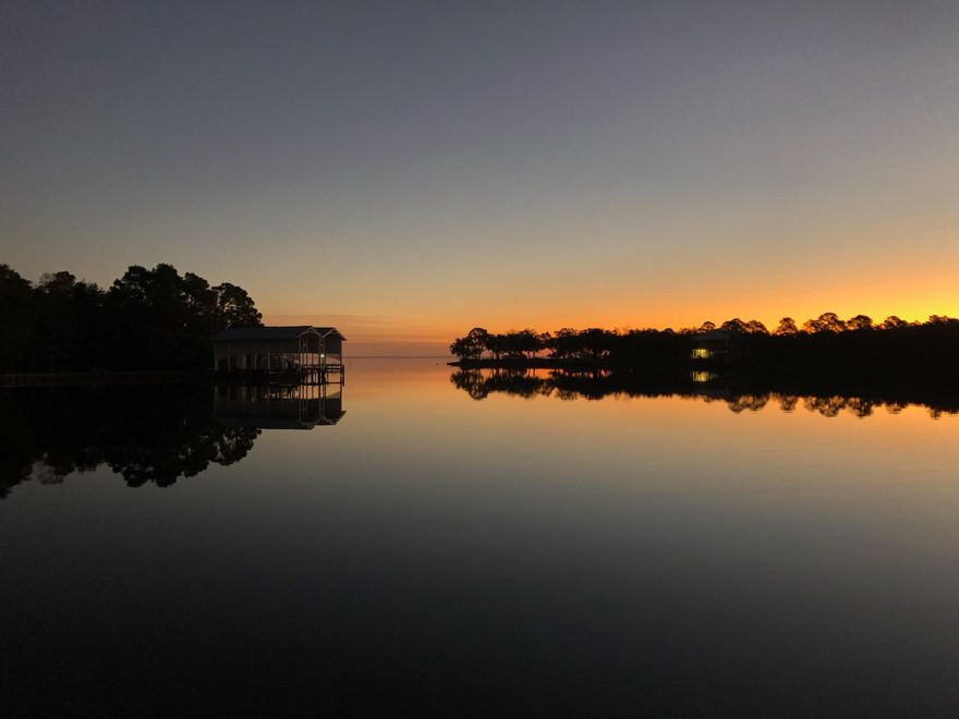 Stunning sunrises and sunsets....NO filter needed from the dock of this coveted deep water access beauty. Perfectly situated on the protected waters of Mack Bayou featuring breathtaking views of the active wildlife on the bayou with a wide span view of Choctawhatchee Bay. This 2 year old thoughtfully designed Buchanan Builders Coastal Elegance with a nod and wink toward traditional New England style. Nestled under the beautiful canopy of the decades old trees of Sacred Oaks subdivision and welcomed by crepe myrtle lined and pavered street. All of the charm of southern living only minutes from 30a beach access as well as the shopping, dining, and entertainment offered by upscale merchants at Grand Boulevard.