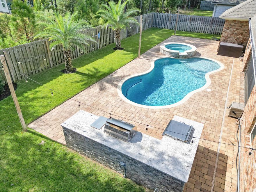 This stunning residence perfectly combines comfort, functionality, and relaxation--ideal for those seeking resort-style living just minutes from the beaches of South Walton. Step inside and be greeted by an inviting open-concept layout with high ceilings and an abundance of natural light. The spacious living area flows seamlessly into the gourmet kitchen, featuring newly painted cabinetry, large center island, stainless steel appliances, and granite countertops--perfect for entertaining. The primary suite offers a serene escape with an ensuite bathroom, dual vanities, soaking tub, seperate shower, and 2 walk-in closets. Step outside and experience your own private backyard oasis. The sparkling pool and spa invite you to unwind, while the outdoor kitchen is perfectly designed for cookouts an gatherings. Whether hosting friends or relaxing under the Florida sun, this outdoor retreat makes every day feel like a vacation.
This home is equipped with modern upgrades for peace of mind and convenience, including a whole-home Generac generator and Starlink high-speed internet. Located in the Hammock Bay master-planned community, residents enjoy resort-style amenities such as walking trails, sports courts, fitness facilities, clubhouse, playgrounds, and a vibrant calendar of neighborhood events.
Only a short drive from beautiful white-sand beaches, restaurants, and shopping, 136 Buxtons Way offers the best of coastal living with small-town charm and modern convenience.