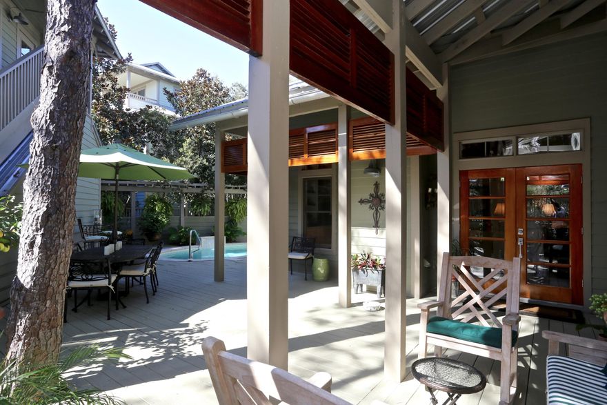 Architecturally designed coastal cottage home with fenced-in courtyard that includes a pool, decking and carriage house, in the gated community of Summer Ridge. Open-concept floor plan with hardwood flooring & vaulted wood beam ceilings. Custom kitchen cabinets, granite counter tops, stainless appliances, 5-burner gas cooktop, two electric/convection ovens, built-in ice maker and wine fridge. The MBR & MBA are located on 1st floor. Wood-burning fireplace, hardi-plank siding & metal roof. California closets in every bedroom. Plantation shutters, wood blinds & ceiling fans throughout. 3rd floor area has a wet bar & wine fridge. Home also includes three HVAC units, security system, multi-zone irrigation with timer, landscape lighting with timer, pool alarm system and outdoor shower