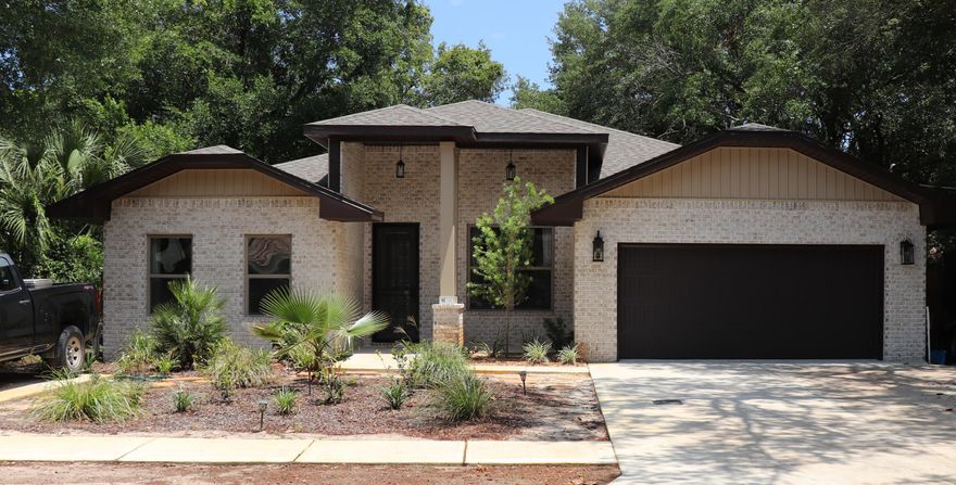 Show anytime This home is 13 months new! Owners relocating. This 4/3 custom brick home has super curb appeal, and is constructed on a lot in a quiet Shalimar neighborhood. There are 10 Ft. ceilings w/ impressive crown molding, plank tile flooring throughout the main living and wet areas, and 5 1/4'' baseboard throughout. 8 Ft. doors are throughout most of the interior of the home. As you enter the home through the covered front porch with custom storm door, the formal dining room is on your right. As you continue down the hallway, you will then enter the chef's delight kitchen which boasts custom painted Ivory cabinetry, granite countertops, 2 large pantry's, and stainless appliances (including an oversized commercial grade refrigerator/ freezer).