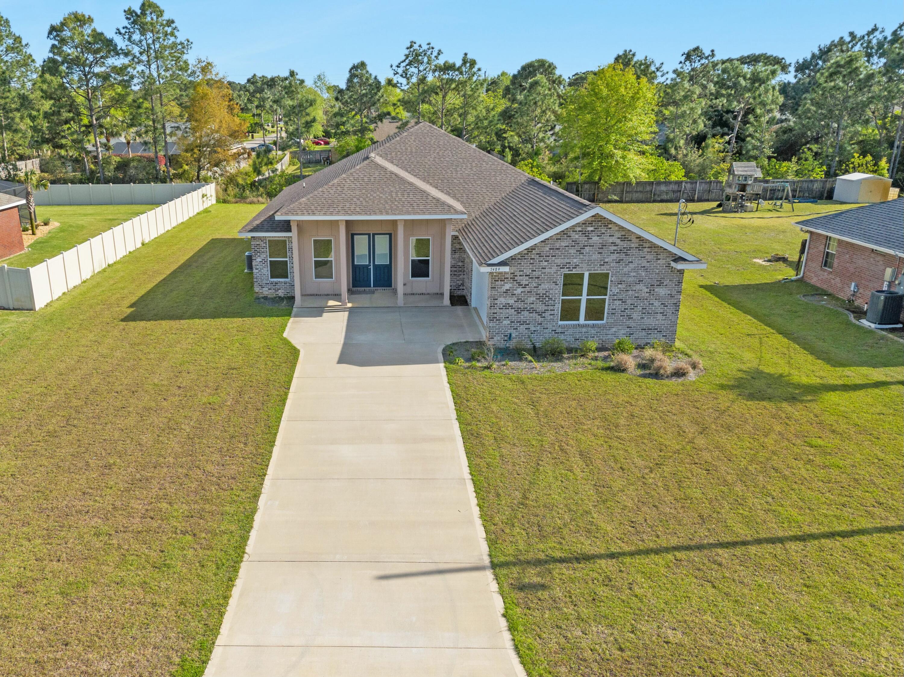 Custom Built home in Holley by the Sea.  This new construction home has the location and upgrades.  This home offers 4 bedrooms and 3 full baths in a split floor plan.  Large open living area overlooked by the large kitchen with wrap around breakfast bar.  The master has an oversized shower and walk-in closet that provide a great space to pamper and relax.The upgrades include quartz countertops, soft close cabinets and drawers, large laundry room with sink and more storage cabinets.  LVP flooring in the main living area and new carpet in the bedrooms.  The large covered porch on back of home will provide a great place to relax as you add amenities to your oversized backyard.  The community is one of the best in Navarre with recreation center, pools, and tennis courts.  Let's connect!