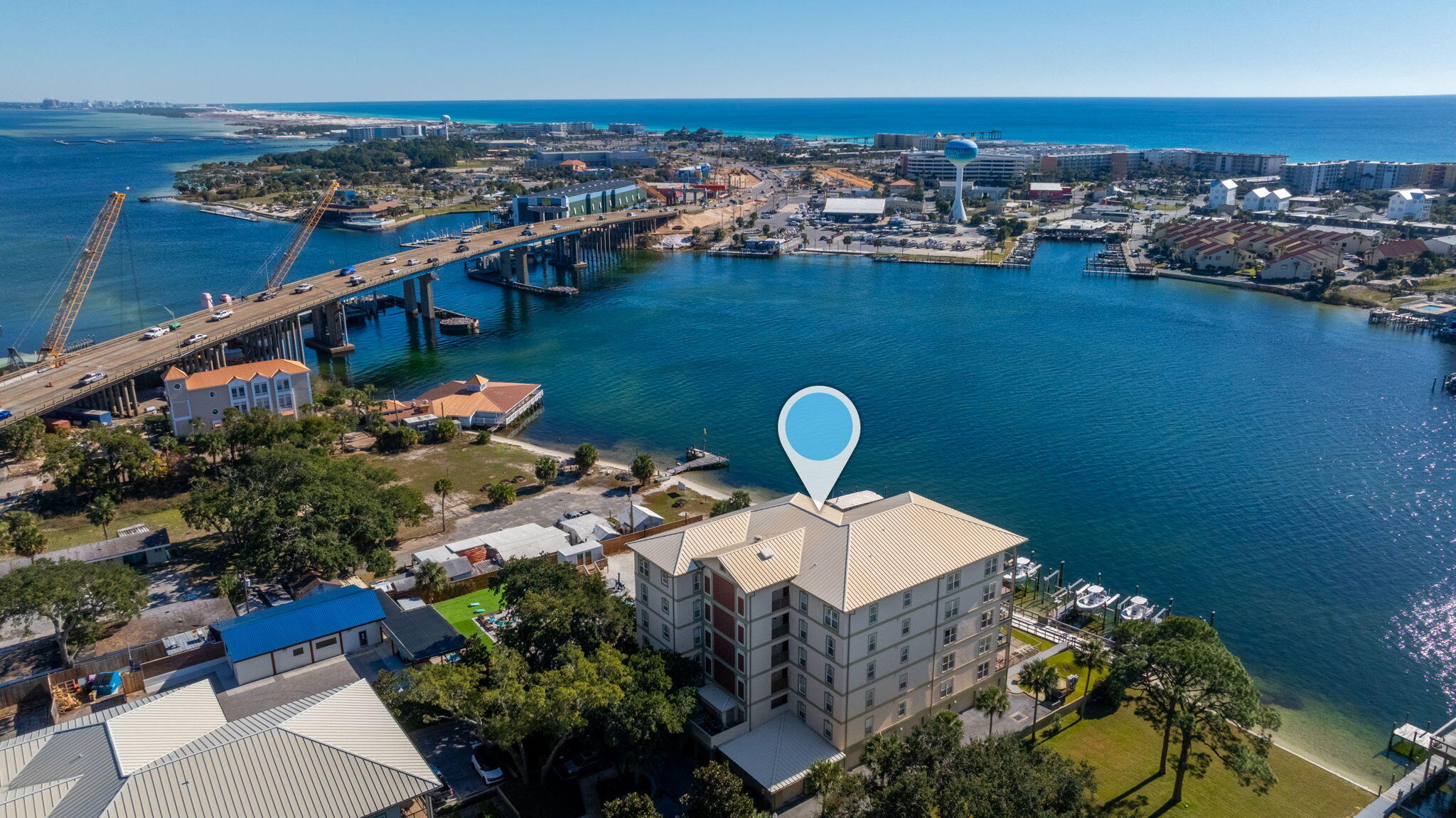 Experience unparalleled luxury in this stunning 6th-floor penthouse in the heart of downtown Fort Walton Beach. Overlooking the tranquil Santa Rosa Sound with sweeping views of the Gulf of Mexico, this exceptional condo is a masterpiece of elegance and sophistication.  The completely renovated kitchen is a chef's dream, featuring high-end Cafe appliances, an induction range exquisite quartzite countertops and backsplash, and custom real-wood cabinets that extend to the ceiling. Stunning pendant lights add a refined finishing touch to the space, perfectly complementing the panoramic waterfront views.  Exclusive to penthouse units, the built-in outdoor gas grill creates the ultimate entertaining experience. Host gatherings on your private balcony while savoring breathtaking sunsets. This 5-bedroom, 5-bathroom penthouse ensures privacy and comfort for both owners and guests, with each bedroom boasting its own en-suite bathroom. The spacious layout is ideal for hosting family and friends without compromising personal space.  

Additional features include a private 2.5-car garage and extra storage, offering convenience and ample room for your belongings. Residents also enjoy access to upscale community amenities, including a sparkling pool, owners' dock, community room, and a fully equipped exercise facility.  

This luxury penthouse is not just a home; it's a lifestyle. Schedule your private showing today and experience waterfront living at its finest.  