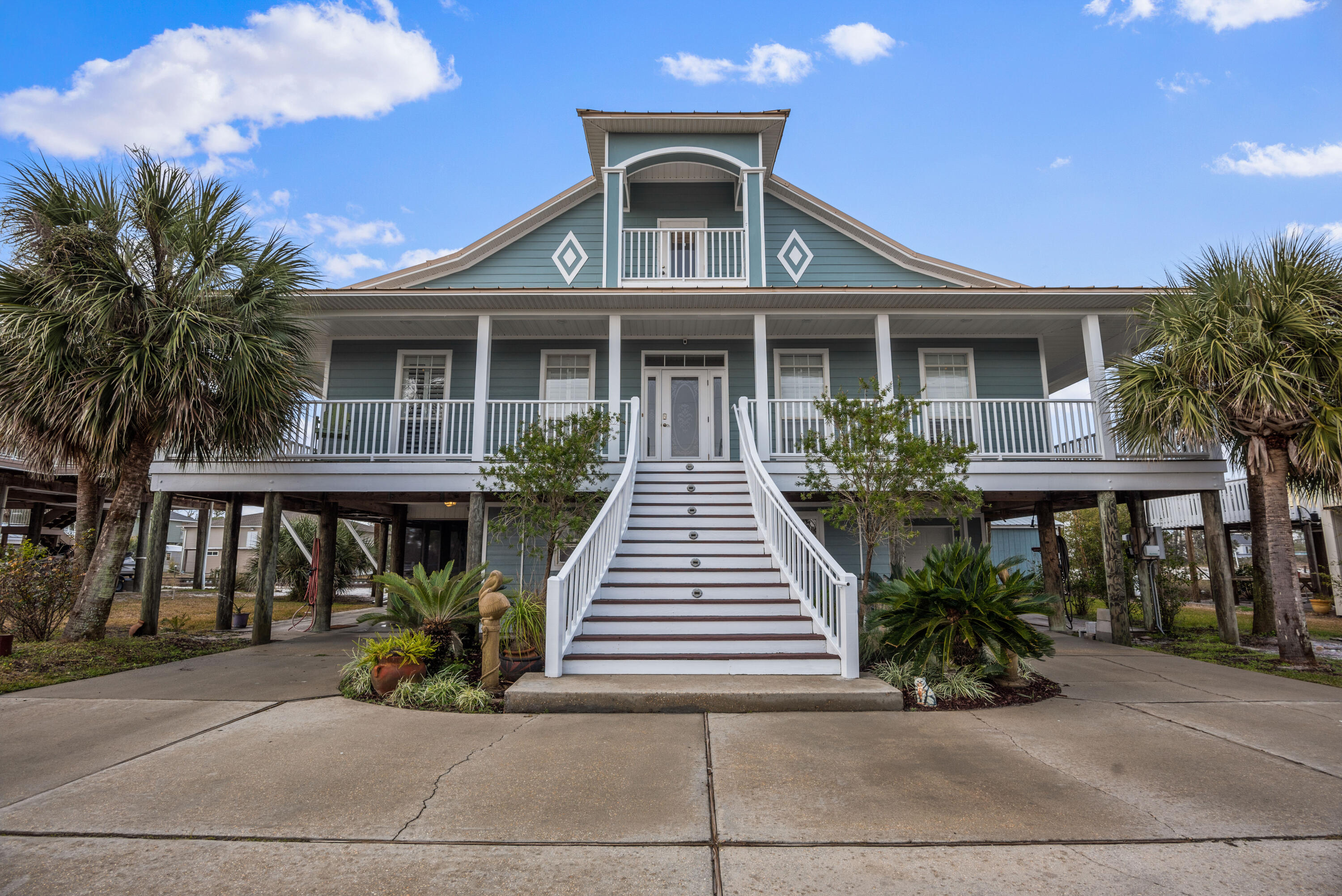 Live like a local. Want to own the lifestyle and a private beach? Look no further! This canal front home features 4 bedrooms, 3.5 baths and breath taking views. Welcomed by a grand center staircase, ample parking and wrap around balconies, this home is the entertainer's dream and boater's paradise. Upon entry, to the right, is the private staircase leading to the secluded primary suite. The oversized bedroom features it's own fireplace, separate seating area with dry bar, 2 private balconies and a expansive walk in closet. On the main level you'll find the ideal layout for entertaining guests or intimate nights in with a separate dining area. The well situated kitchen and large island open to the bright and airy living room full of natural light.