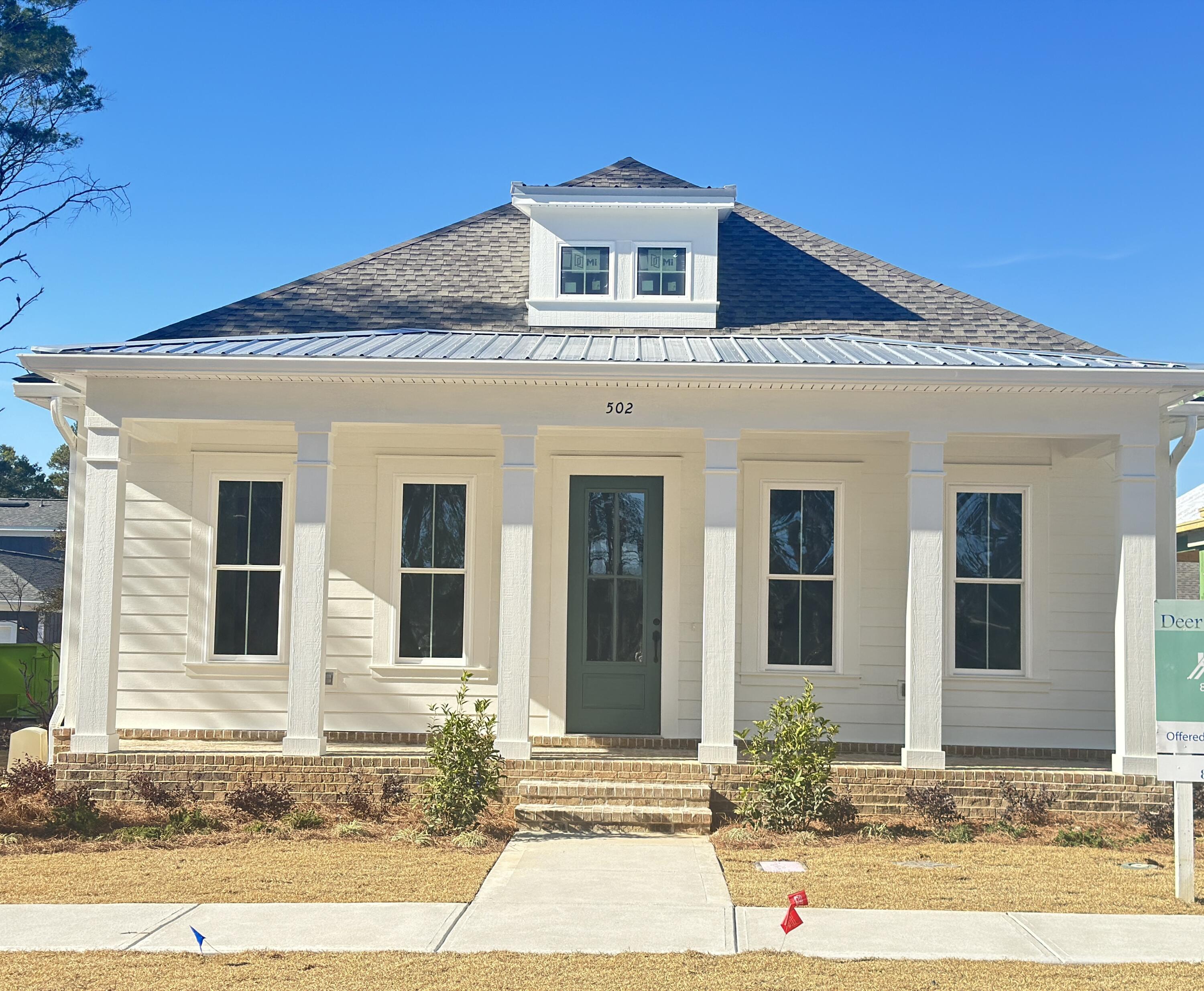 Welcome to this rare jewel with rear loading THREE CAR GARAGE and just across the street from DMC amenities that are under construction to include pool, clubhouse, basketball, gazebo and green space! This charming 3 BR, 2.5 BA home also has a flex space that can be used as an office or sun room. Upon entering, you will find modern lighting and beautiful luxury vinyl flooring. Complete with kitchen island and bar seating, Kitchen Aid appliances, quartz countertops and backsplash and open concept living, this home is ready for entertaining family and friends. Back porch is stubbed for gas grill and boasts beautiful brick pavers. Buyer to verify all dimensions. Seller will pay Title and Doc Stamps. Call for more more information.