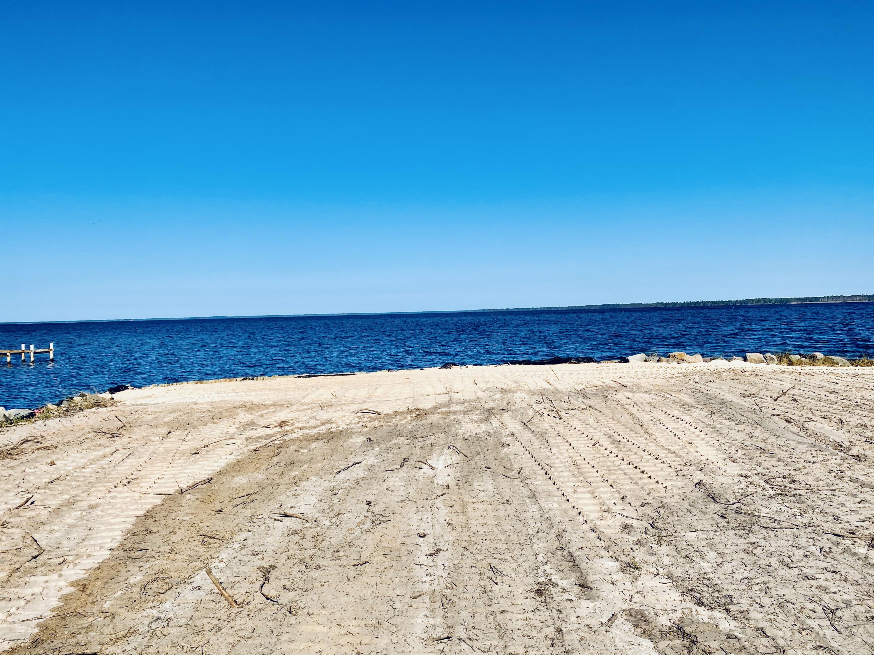 Beautiful cleared waterfront lot almost an acre in size with 85 feet of water frontage. Rip rap and a seawall are already there, plus a protected small canal that could be a boat/kayak launch. Great open views of the bay with good water depth make this a place to boat, fish, or just enjoy the amazing views. Lot is cleared all the way down to the water so go take a look today!