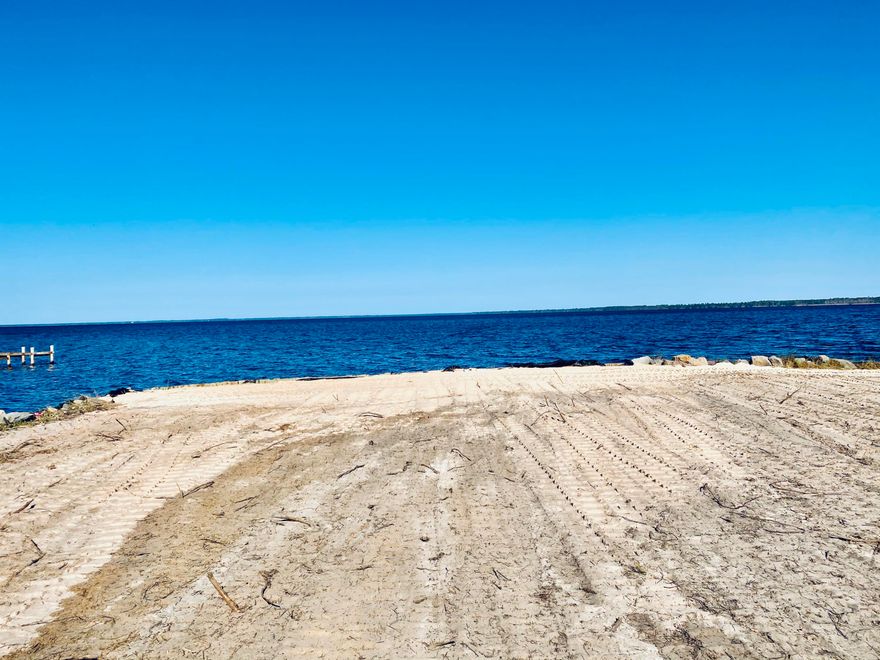 Beautiful cleared waterfront lot almost an acre in size with 85 feet of water frontage.  Rip rap and a seawall are already there, plus a protected small canal that could be a boat/kayak launch.  Great open views of the bay with good water depth make this a place to boat, fish, or just enjoy the amazing views.  Lot is cleared all the way down to the water so go take a look today!
