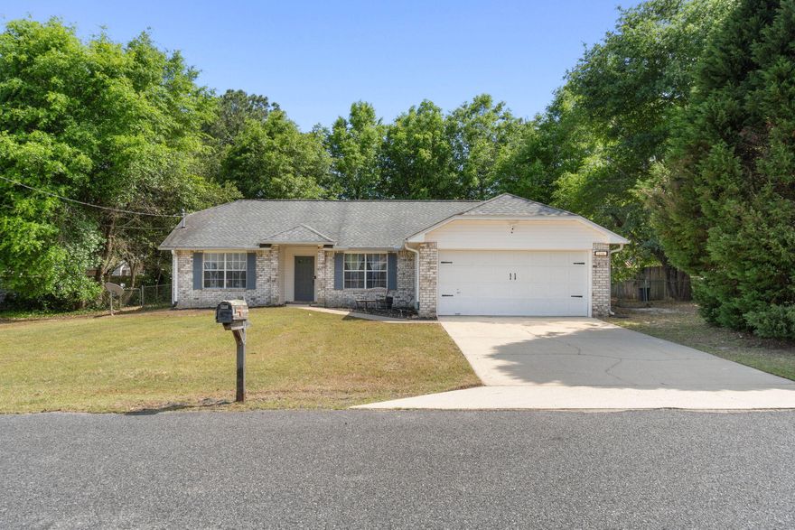 Welcome to this move in ready home on a large FLAT lot SOUTH of I-10 in Crestview! Appreciate this split floor plan featuring the owner's suite on one side of the house and two additional bedrooms on the other with a flex space open to the great area with wood look tile throughout! The bright kitchen offers a convenient center island as well as a breakfast nook with brand new stainless steel appliances! The owner's suite features a bathroom with TWO walk in closets as well as a double vanity and linen closet. On the other side of the house you'll find the additional two bedrooms with ample closet space and a shared full bathroom as well the interior laundry room that leads to the two car garage. There is a sliding glass door that leads out to the large and flat fenced in backyard where