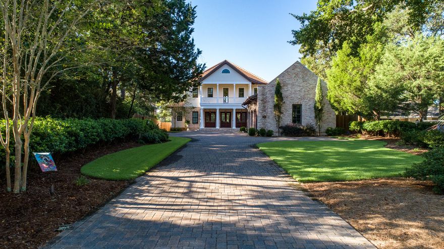 WATERFRONT ARCHITECTURAL MASTERPIECE! From the minute you drive up the pavered driveway you'll notice the quality and details everywhere. Step into the foyer to find columns, Victorian hotel pendent RH lighting and a dramatic open staircase with custom wrought iron. Spacious living area with beamed ceiling, custom built-in cabinets, gas fireplace, wide plank re-claimed heart pine flooring throughout, and windows that span the breathtaking views of infinity pool and water. Entertaining will be a delight in your open concept dining area with two built-in buffets. Gourmet kitchen is top-of-the line with Thermador appliances, sub-zero icemaker and beverage cooler, custom cabinets with glass fronts above, beautiful granite counter space, and large center island with a breakfast bar.