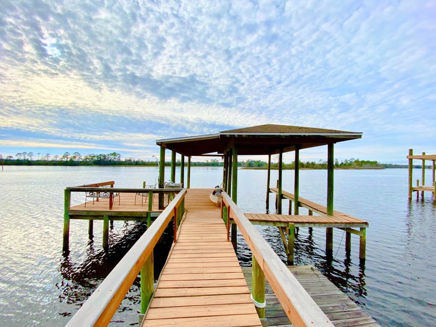 Feel like you are on vacation everyday in this waterfront home nestled on close to 1 acre with private dock! As you enter the bright foyer of this nearly 3000 square foot meticulously kept home you immediately notice the details that have gone into every aspect of the design. Energy efficient upgrades including a new roof, added attic insulation, updated windows and much more! With 4 bedrooms and 3 full bathrooms there is plenty of room for family and guests alike. Entertaining is a breeze from the large family room or your expansive Florida Room with wall to wall water views. Take your boat out on the Blackwater Bay and enjoy fishing and relaxing from your private dock, or set up a chair and relax on your very own white sandy beach!