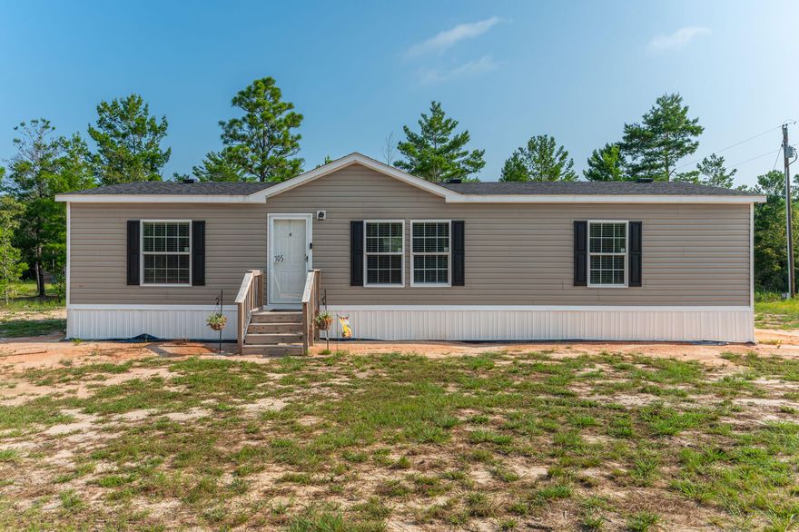 This 2022 manufactured home sits on a .23-acre lot and offers 1,352 sq ft of comfortable living space. It features 3 bedrooms, 2 baths, and a split floor plan. The home is equipped with central air conditioning and heating. The kitchen includes matching appliances and a breakfast bar. Carpeted living area and bedrooms, with vinyl flooring in wet areas. The ensuite boasts a separate walk-in shower and a large tub. Each bedroom has a spacious closet, providing ample storage. This home is priced to move. Don't miss the opportunity to make it yours.