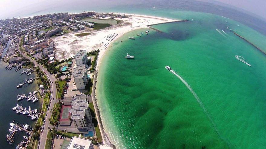 Experience this fabulous unit facing the Destin East Pass & looking on to the Gulf of Mexico. This was the only unit with the Aruba floor plan in the entire building and was modified & customized by the seller's own architect to make it the best! Many upgrades make this truly one of the nicest 2 bedrooms you will find in Destin. Travertine & wood moldings add to the feel of this luxurious but cozy unit. It comes complete with an enclosed garage which is the closest one to the beach. The owners used it more as a cabana for cooking out and enjoying family days at the beach since it was so conveniently located. Also included with the unit, is a separate storage unit downstairs. This condo can be sold with a boat slip as a package for $615,000. 3 Month Minimum rental period. The boat slip will accommodate a 55 ft. boat. A must see - never offered before. All room dimensions to be verified by buyer.