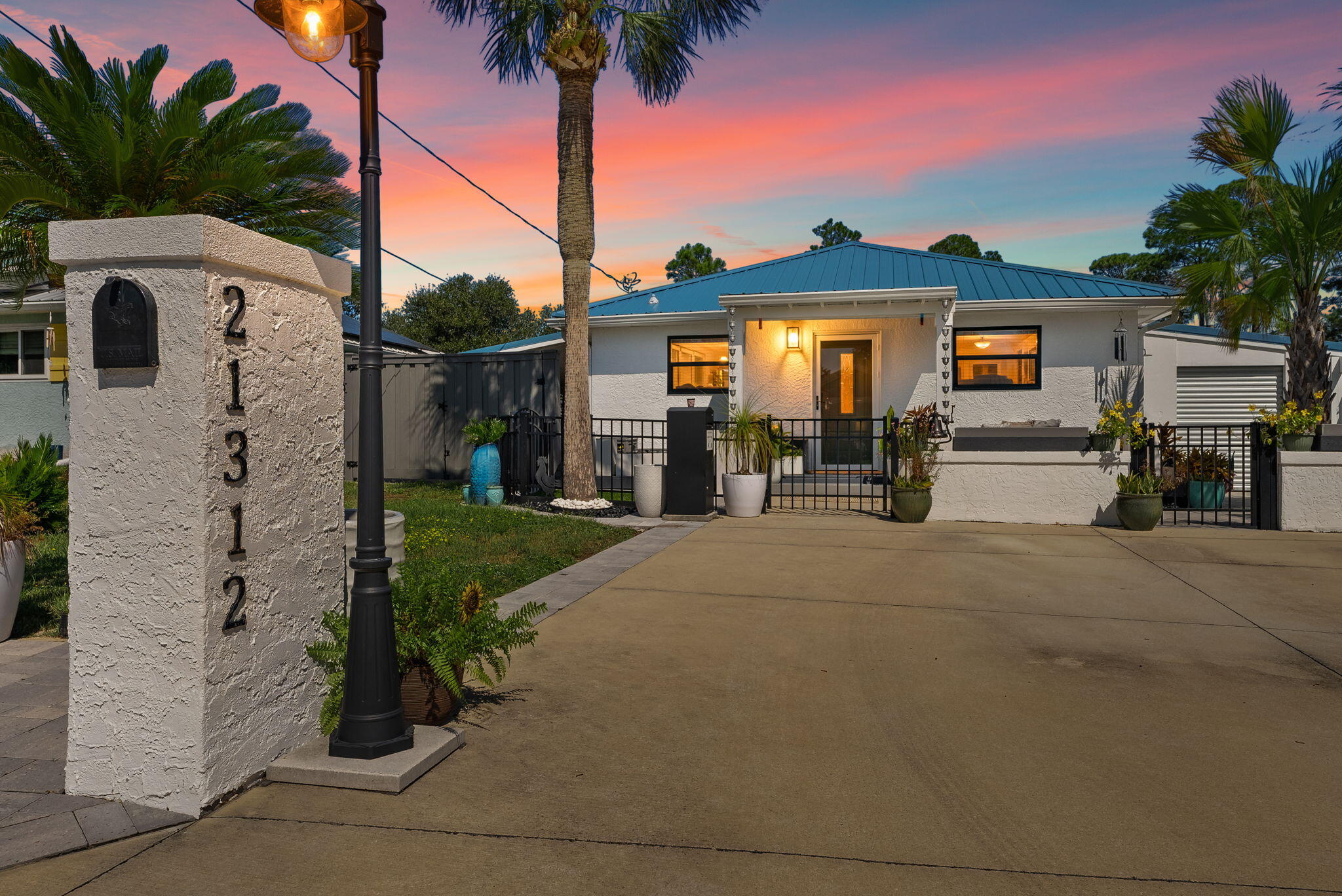 Welcome to 21312 Hilltop Ave--an upgraded Florida Coastal Cottage on the quiet west end of Panama City Beach. This fully enclosed corner lot offers privacy, golf-cart access to Beach Access 87, and over $100K in improvements. Enjoy a Trex front porch, paver driveway, fenced yard with decorative columns, and a backyard retreat featuring a putting green, turf lawn with drainage, and an outdoor kitchen with grill, sink & refrigerator. Metal roof (2022), impact windows, new septic (2022), HVAC (2019), and water heater (2021) provide turnkey peace of mind. A true blend of comfort, convenience, and modern coastal living--minutes from 30A, Pier Park, and ECP, with no HOA. This Panama City Beach property has received over $100K in improvements designed for comfort and long-term value. A Trex privacy fence, custom gates, and a stuccoed concrete wall with decorative columns, and multiple access gates, surround the home, with black wrought iron fencing and gates accentuating the front of the home. The 26' x 7' Trex front porch (2022), covered carport with double gates, and upgraded driveway with paver extension (2024-2025) provide versatile outdoor living and curb appeal.
The backyard is a true lifestyle retreat, featuring a private putting green, turf lawn with intentional drainage beneath to allow drainage to the edges of the property, mature landscaping, and large planters. An east-side outdoor shower adds coastal convenience, while the west-side entertaining area is equipped with a working sink, refrigerator, and grill. Multiple gated entry points, including a golf cart garage with drive-through access, make beach days effortless and highlight the home's versatility.
Premium updates include a raised seam metal roof (2022) with new gutters, PGT hurricane-rated impact windows, Therma-Tru doors, and tinted storm doors. Essential systems have also been upgraded: new septic system (2022) with the old one removed not just crushed, HVAC (2019, serviced bi-annually, last inspected 2025), and water heater (2021). These improvements offer peace of mind and reduce future ownership costs and insurance discounts.
Inside, the home offers a bright, open layout with quartz kitchen countertops, durable finishes, and two full bathrooms. Buyers can enjoy a move-in-ready experience with the opportunity to personalize the interior to their taste while major structural investments are already complete.
Completely enclosed and designed with both privacy and lifestyle in mind, this Panama City Beach home in the golf cart friendly community of Riviera Beach is ideal as a primary residence, second home, or vacation rental. With proximity to the sugar-white sand beaches of the Emerald Coast, dedicated golf cart parking at nearby public accesses, and every major update already in place, 21312 Hilltop Avenue presents an exceptional coastal real estate opportunity in Florida.