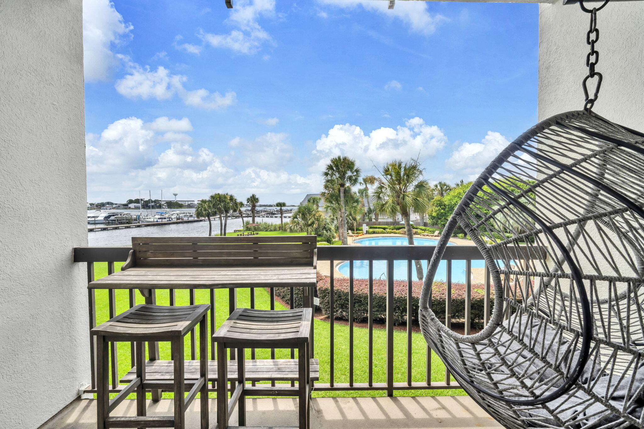 Santa Rosa Sound Access + 36' Boat Slip - Ready for Rental Income! This beautifully styled, fully furnished studio features warm coastal decor, modern finishes, and wood-look laminate flooring for an upscale beach vibe. The remodeled kitchenette includes an induction stovetop and Apt-size fridge--perfect for guests or weekend getaways. Step onto the balcony and unwind at the bar-height dining set while enjoying tranquil pool views--ideal morning to evening. Access Santa Rosa Sound via the private beach area for kayaking or paddleboarding. The 36' boat slip can be rented short or long term. Deep soaking tub with cultured marble surround. New A/C (2024). Laundry on each floor. Owners may have pets. Minutes to Destin, dining, and beaches!
