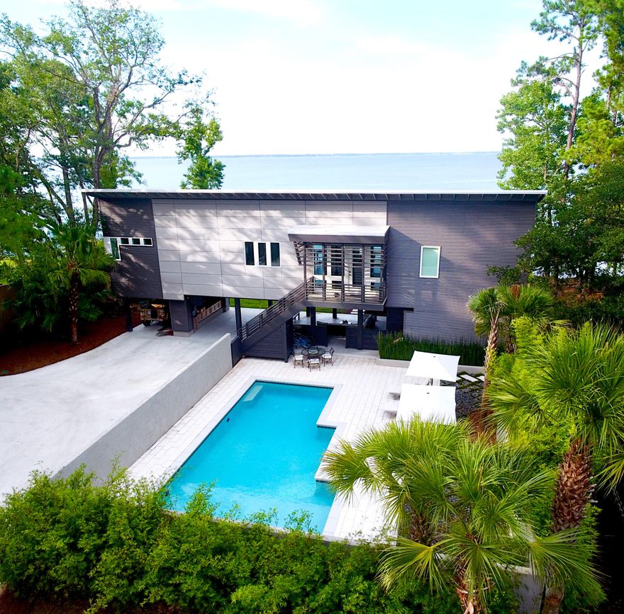This modern bay-front home enjoys spectacular views across Choctawhatchee Bay and is just a few minutes away from Gulf Place and Florida's famous Scenic Highway 30A. Once featured on the cover of VIE Magazine, this 2,200 square foot home features 3 bedrooms and 3.5 bathrooms. The home sits on a private, fenced one-acre lot surrounded by palm and oak trees. There home features a huge private pool, a covered outdoor lounge, spacious grass yards, a dock with a paddleboard platform, and a boat lift that can dry-dock a boat up to 24' long.

The home's bright and open floor plan home features a chef's kitchen with a Thermador oven/range and quartz countertops. The Master Suite offers breathtaking views of the bay, spacious his-and-hers walk-in closets with built-in cabinets, a spa-like  rainshower and an infra-red sauna.

Close to everything that Scenic 30A has to offer, this home is set far back off an already-quiet street. There are two covered parking spaces, a parking pad for additional cars, an outdoor grill and a fire pit. This "smart home" features automated interior and exterior lights, door locks, thermostat and security system, all powered by Alexa or your mobile phone. There are automatic landscape lights and an irrigation system that uses free well water. There is no HOA. Landscaping, pool maintenance and pest control are included with this rental. This is unquestionably the most impressive long-term rental property available in South Walton, and the home can be rented furnished or unfurnished.

The Beach Sunsets Inc. Resident Benefits Package is designed to provide convenience and professional services to our residents. By applying, Resident(s) agree to be auto-enrolled in the program and pay an additional $25.00 each month, payable with rent. This program includes benefits such a Tenant Portal for online payments, 24/7 maintenance requests, air filter(s) auto shipped to your door, waived lease, lease change and administration fees and more! Benefits of this package may vary due to the property specifications. No discount will be given if an element of the package is not available. The cost of this package is all-inclusive.