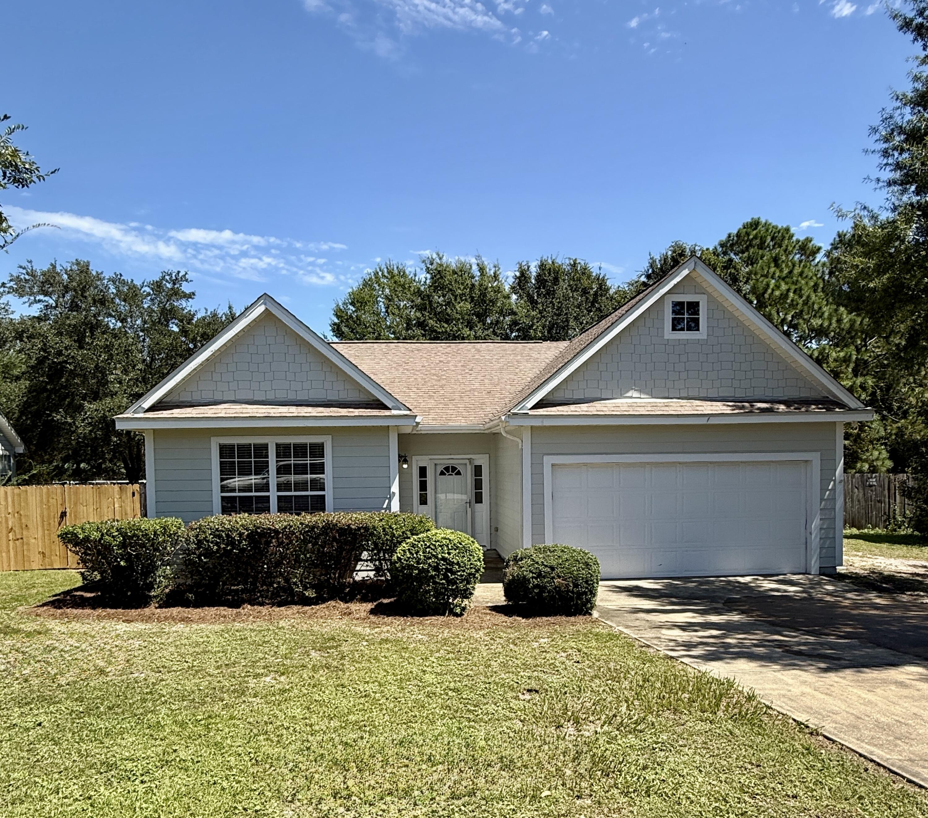 New roof with Full Price Offer!-Welcome to 132 Peoria Blvd -- a private retreat tucked just south of Crestview, offering quick access to Fort Walton Beach, Destin, and all local military bases. Set on nearly an acre with mature trees, this property features a spacious deck overlooking a peaceful creek and fire pit, perfect for outdoor gatherings. Inside, you'll find two master suites and a generous living area surrounded by natural woods, creating a warm and inviting atmosphere. House included nice workshop in rear of property. Enjoy the blend of convenience and tranquility in this rare find!
