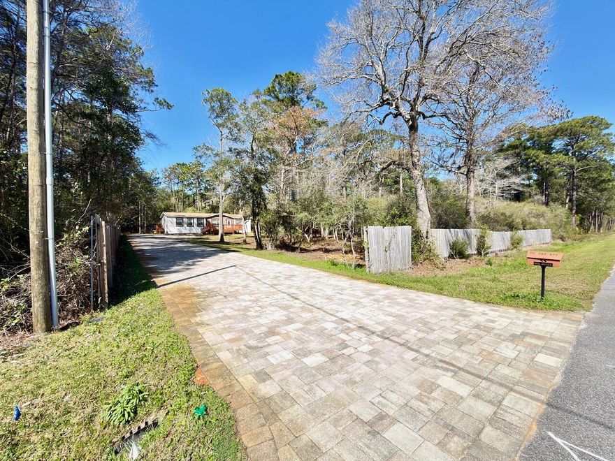 ''Permanently affixed and converted to real property with retired title.''1 acre, near water, newer home (2022), paved driveway, fenced yard, permanent foundation, and privacy! Rare opportunity to own a private one-acre property just one block from Choctawhatchee Bay and approximately two miles from the white sandy beaches of South Walton. This 2022-built 3-bedroom, 2-bath home sits on a fully fenced one-acre homesite with a paved driveway and peaceful wooded surroundings, offering privacy and space that are increasingly difficult to find in Santa Rosa Beach. The home is permanently affixed with retired title and constructed on a reinforced engineered foundation system featuring CMU piers, concrete footings, and steel beam support, providing the stability and benefits of real property owner "Permanently affixed and converted to real property with retired title."

1 acre, near water, newer home (2022), paved driveway, fenced yard, permanent foundation, and privacy! Rare opportunity to own a private one-acre property just one block from Choctawhatchee Bay and approximately two miles from the white sandy beaches of South Walton. This 2022-built 3-bedroom, 2-bath home sits on a fully fenced one-acre homesite with a paved driveway and peaceful wooded surroundings, offering privacy and space that are increasingly difficult to find in Santa Rosa Beach. The home is permanently affixed with retired title and constructed on a reinforced engineered foundation system featuring CMU piers, concrete footings, and steel beam support, providing the stability and benefits of real property ownership. The expansive lot offers ample room for boats, RVs, trailers, outdoor storage, gardening, or future additions such as a workshop, garage, or pool, making it ideal for buyers seeking flexibility and freedom without HOA restrictions. Located just minutes from bay access for fishing, boating, kayaking, and paddleboarding, and a short drive to the Gulf beaches, 30A, shopping, dining, and entertainment, this property offers a rare combination of acreage, newer construction, privacy, and proximity to the water in one of South Walton's most desirable areas.