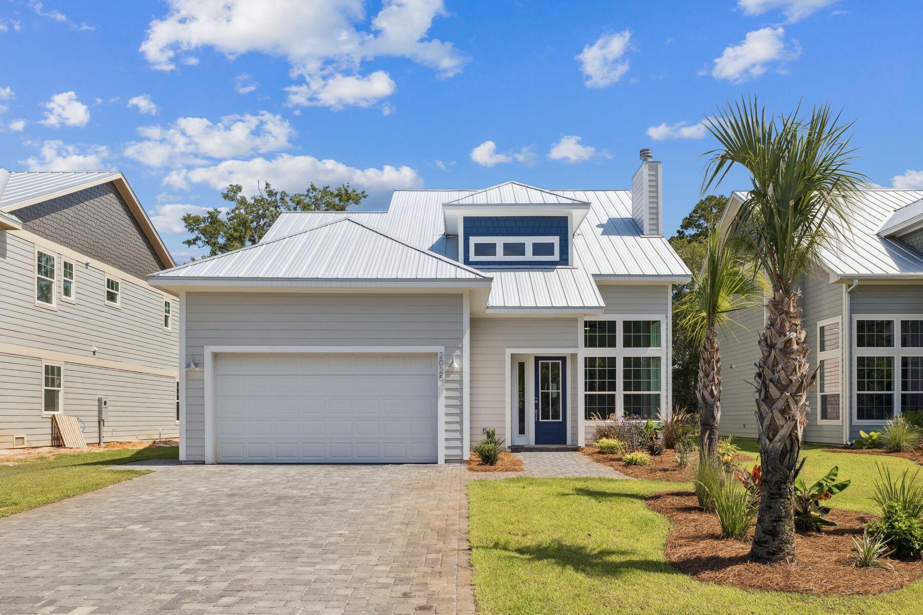 Enjoy waterfront living and your own private boat dock at this luxury residence in Eagle Bay. Located on a tranquil canal with direct access to stunning Choctawhatchee Bay, this beautifully crafted home is designed for the ultimate lifestyle. Nestled in dappled shade on a tree-lined lot, it includes a two-car garage for storing kayaks and paddleboards when not in use. Stepping through the front door, you'll immediately appreciate the double-height foyer leading into a light-infused living room. Huge windows reach upward to the soaring cathedral ceiling, delivering a sense of airy spaciousness. Light wood flooring flows seamlessly throughout the entire home, lending a fresh, clean look to each artfully designed space. A stunning marble fireplace with shiplap provides an attractive focal point in the sitting area. To the rear of the home, an angled bar defines the gourmet kitchen area, which has an additional island for storage and food prep. Complementing the stainless steel appliances, subtle dove gray cabinets reach to the ceiling, providing additional storage. Hop onto stools at the bar and enjoy cocktails and appetizers while socializing with the chef. Move into the defined dining area for dinner when entertaining family and friends. Tall windows provide picturesque views of mature trees lining the canal. The backyard and dock provide a peaceful spot for alfresco barbecues or relaxing with a book while children play. A boat will provide hours of fun fishing, boating, and taking trips to the beach. A half bathroom and a laundry are conveniently located on the first floor, along with the master bedroom. Wake up to stunning views each morning through tall windows that reach up towards the soaring ceiling. A walk-in closet and a luxurious bathroom with a marble-tiled shower and a deep soaker tub make this a haven of rejuvenation. Wood-tread stairs lead to three more bedrooms and a family bathroom on the second floor. There's ample space to accommodate family or entertain overnight guests in these generously proportioned rooms, all with closets. Serene waterfront views are ever-present. This enviable home is one of a select few waterfront residences in this exclusive new community, just minutes from a supermarket, restaurants, golf, and activities at Topsail Hill Preserve State Park.