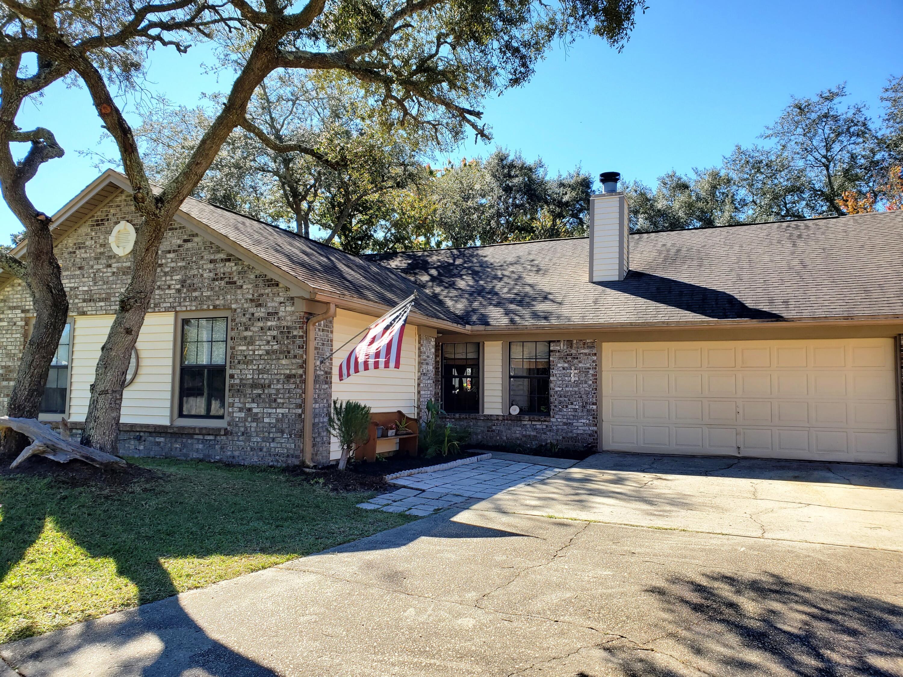 Prime beauty in one of the most desirable neighborhoods in West Destin, Bayview Manor. Great location in Old Destin and 2 minutes from the Bay and Joe's Bayou Boat Ramp. You will love the cozy feel and ambiance of this charmer, with four bedrooms and three full baths for the kids or extended family. Modified open floor plan with the skylighted kitchen opening up into a large living area with wood fireplace and the semi traditional dining room just off the main living area. Four bedrooms with two master suites, one having a walk-in closet off the master bath. Step out the rear door to a newly renovated elevated deck and enjoy the backyard, which is fully fenced and landscaped and populated with beautiful oak trees, a navel orange tree, and fig tree.
