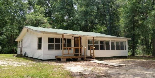 REO This is .83 of an acre not far from the town of Florala. With some TLC this would make a great family home. Large kitchen with open dining area and living room with Florida room on the front of the home. Genuine hardwood floors in bedrooms. Great back yard with enough room for the play set or above ground pool.