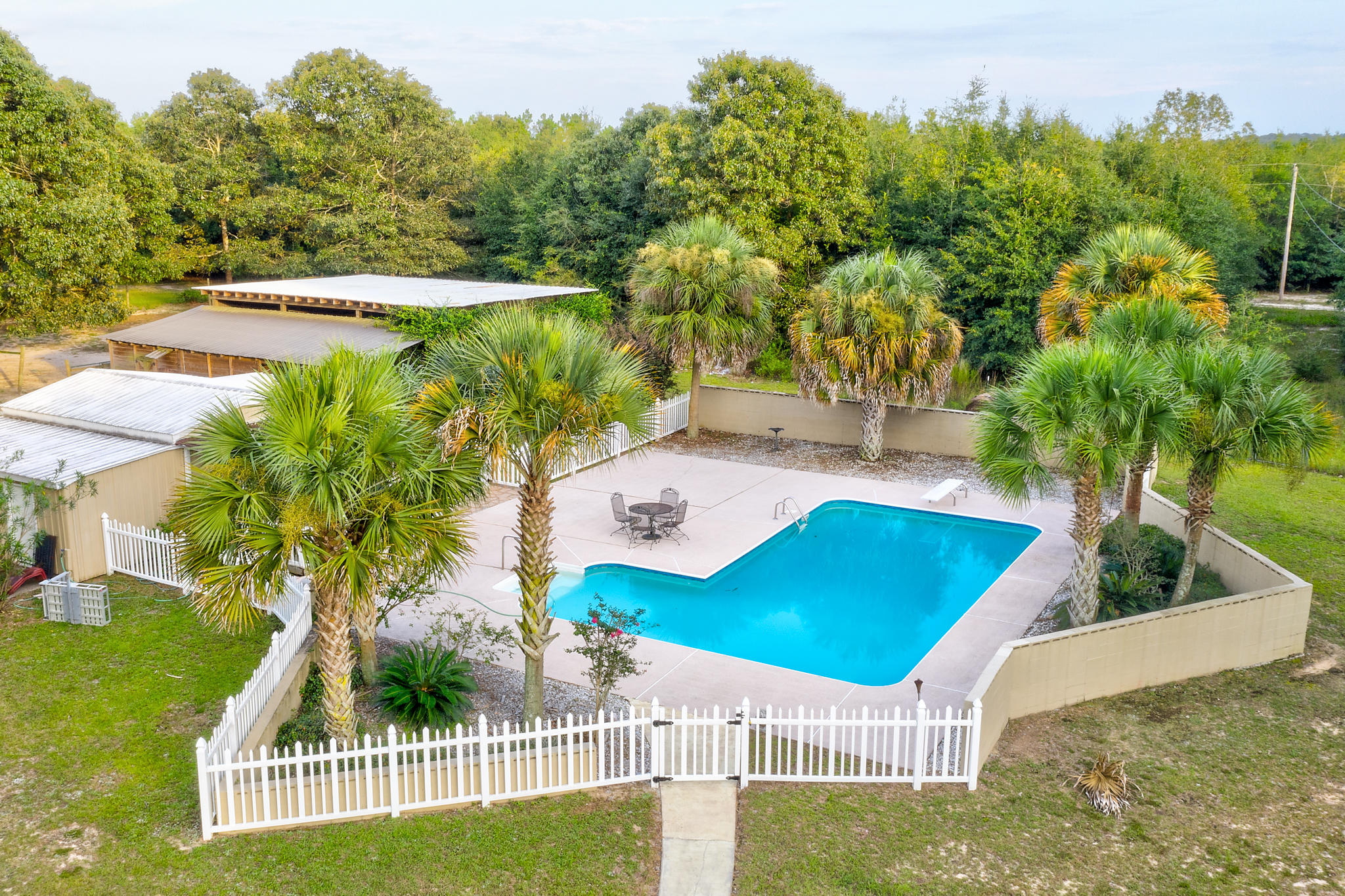 Do you want to ride your horses or swim in the gorgeous pool today? This beautiful country home has it all. Large family room and good sized bedrooms are also a plus. The Living room looks out onto the huge covered front porch which is the length of the home. Stables are large enough for 2 horses and plenty of room for hay & feed. Excellent property in good location. RV hook up & lots of space for your beautiful ponies. Whats not to love? Minutes from Interstate 10. Great opportunity for country living!