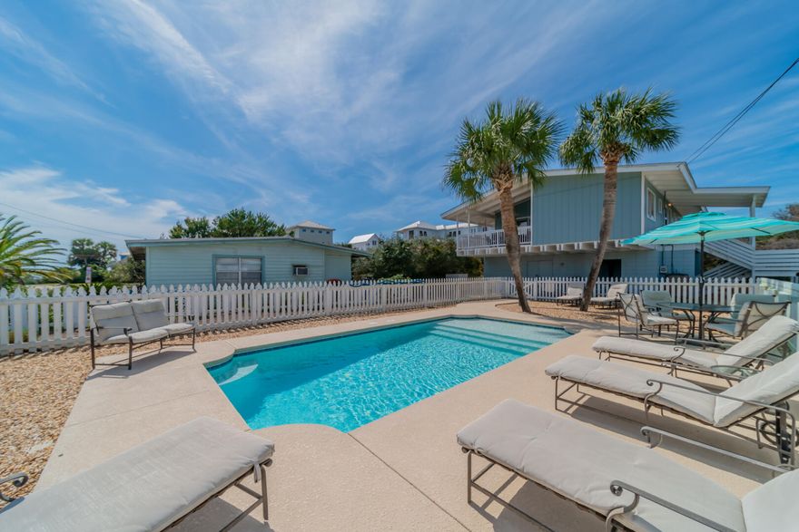 This charming ''old Florida'' style two-story fully furnished beach cottage in the tranquil community of Inlet Beach features 3 bedrooms and 3 baths. This charming coastal retreat is ideal as a primary residence, second home, or investment property. The outdoor oasis includes a fenced-in pool area surrounded by mature palms and coastal landscaping.  The second-floor main living area includes an open-concept kitchen, dining, and family room with abundant natural light.  The expansive wrap-around deck gives access to multiple outdoor seating areas, perfect for outdoor dining, lounging, or taking in the ocean breeze.  The upstairs primary suite offers a spacious layout, king-sized bed and serene views. A private guest suite located downstairs features a king bed with private ensuite bath.
