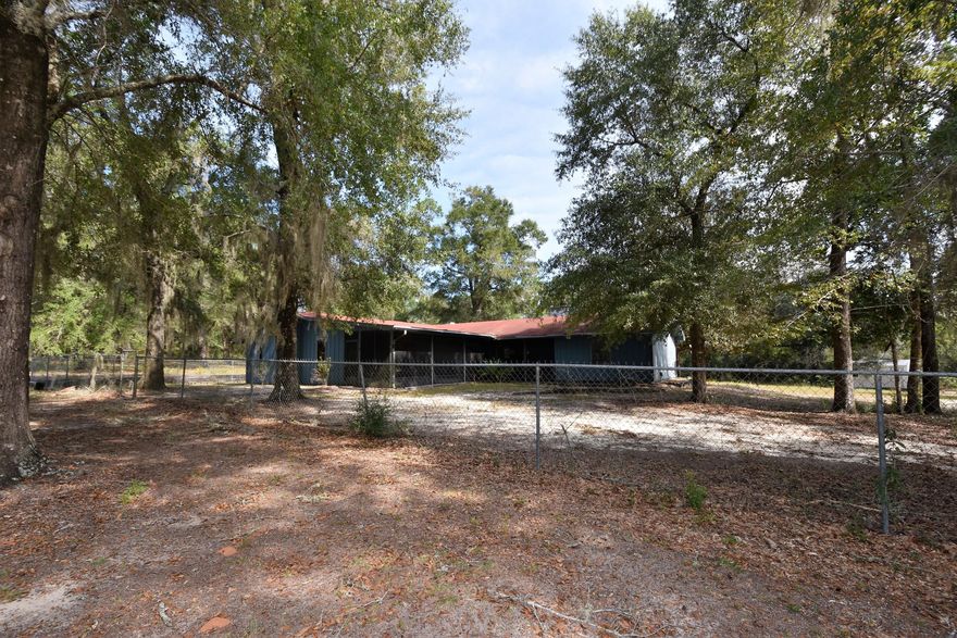 4 + Acres and 2,600 + sq.ft. home w/great floor plan ready to renovate! 4 Bedroom, 3 Full Bathrooms, Two Living Spaces w/stone fireplaces, and SCREENED PORCH perfect to enjoy your wooded acreage. Portion of the property is fenced, circular drive, and TONS of potential! Excellent habitat for the abundant wild life near the Yellow River Watershed for: Deer, Turkey, and Wild Hogs; just to name a few! Opportunity to make the improvements you want! View this beautiful acreage and home today! Exact dimensions to be determined once new survey is completed. House needs wiring, plumbing, HVAC and more.